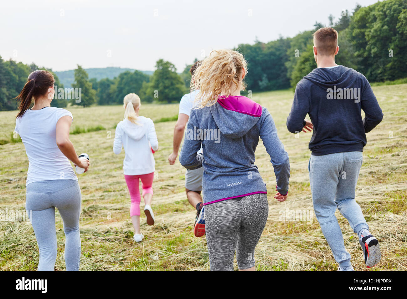 Gruppe von jungen Leuten zusammen Joggen im Park im Sommer Stockfoto
