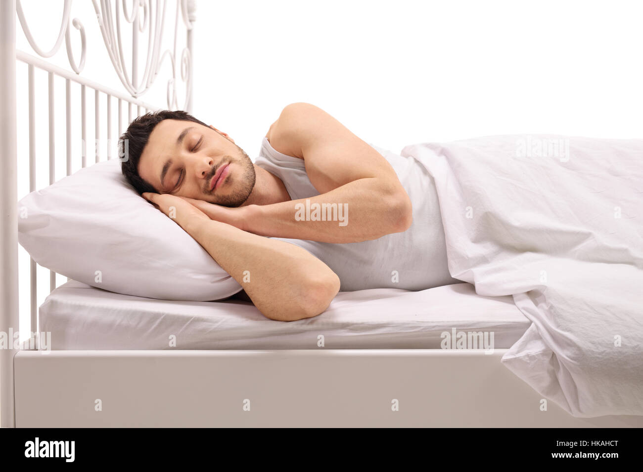 Mann schläft bequem im Bett isoliert auf weißem Hintergrund Stockfoto