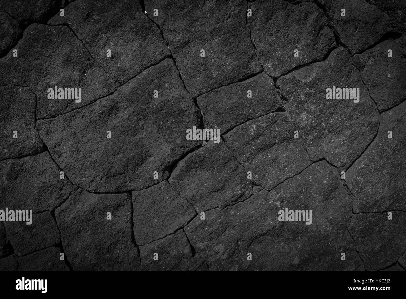 Dunkel grau schwarze Wand Stein Hintergrund oder Textur-Lava Textur Stockfoto