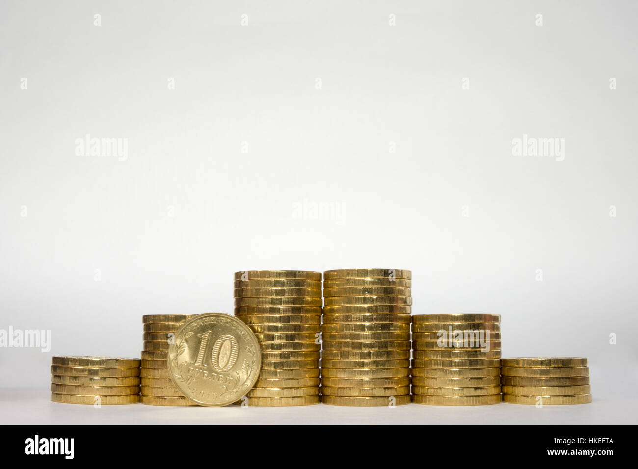 Sechs Stapel von Münzen zunehmender Höhe symmetrisch auf einem weißen Hintergrund, pockennarbige steht am Rande des russischen 10-Rubel-Münze Stockfoto