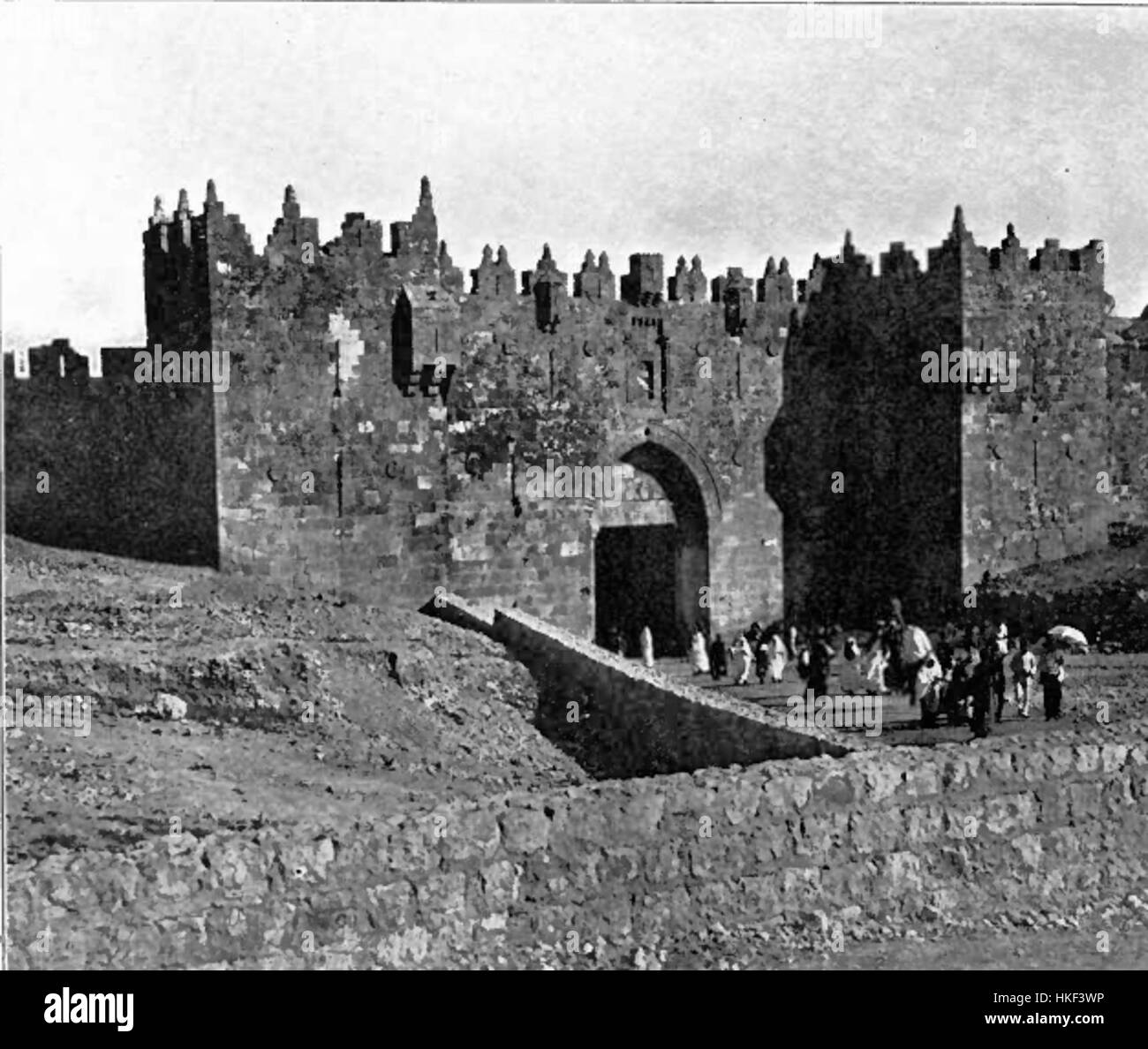 Diese 1906 gezeigte Darstellung des Damaskus-Tors in Jerusalem zeigt die architektonische Pracht eines der ältesten und berühmtesten Eingänge der Stadt. Das Werk spiegelt die historische Bedeutung und das komplizierte Design des Tores wider, ein wichtiger Teil der Verteidigungsmauern der Stadt. Stockfoto