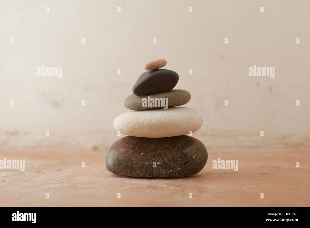 Ein Stapel von Steinen mit Grautönen auf einem rustikalen Hintergrund Stockfoto