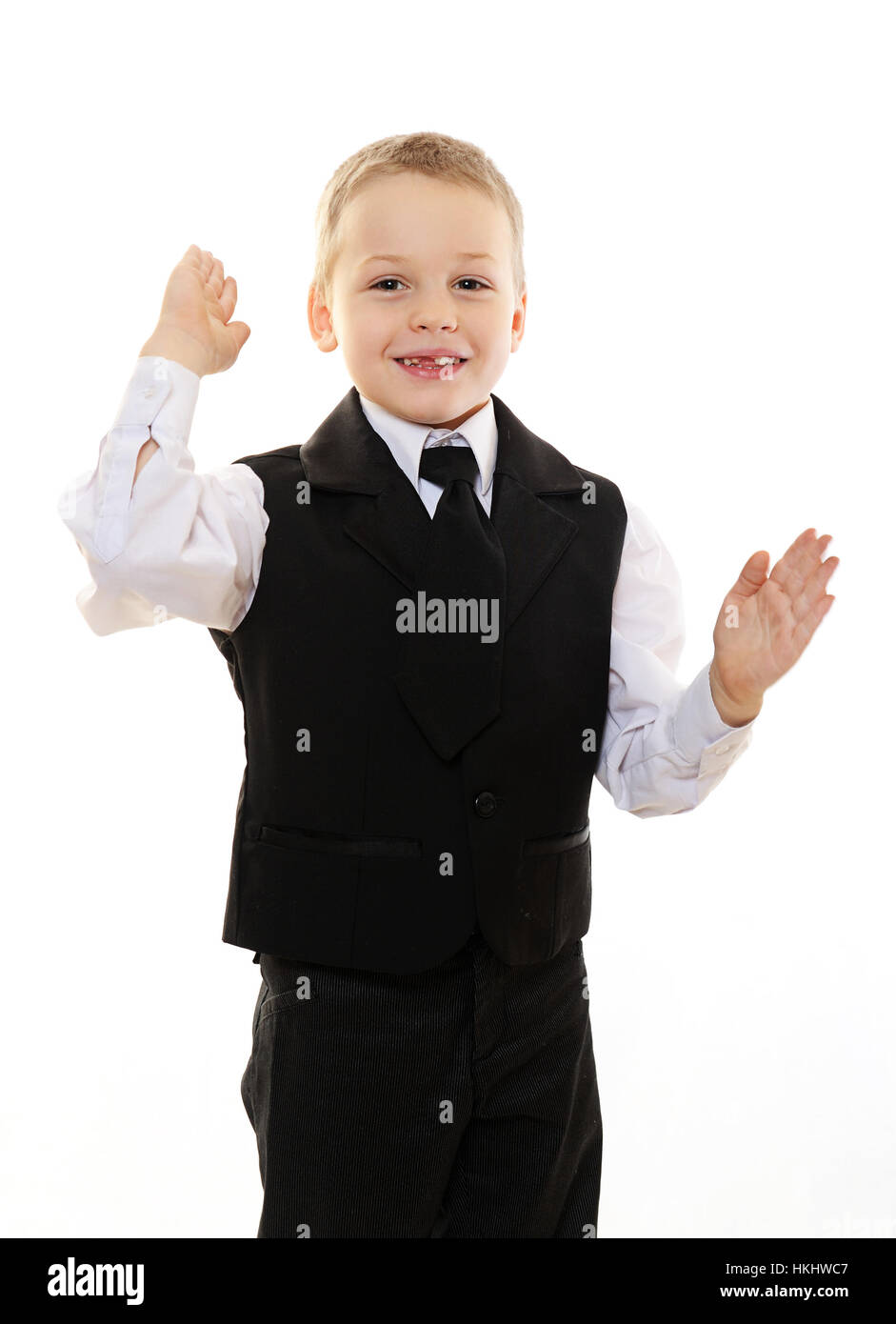 fröhlicher Junge Kind im schwarzen Anzug, isoliert auf weiss Stockfoto