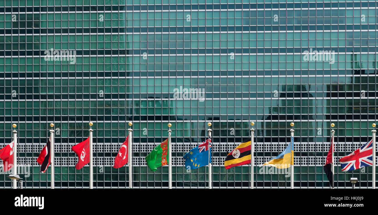 Internationale Fahnen in einer Reihe vor einem Sitz des UNO-Gebäudes mit Glasfassade Stockfoto