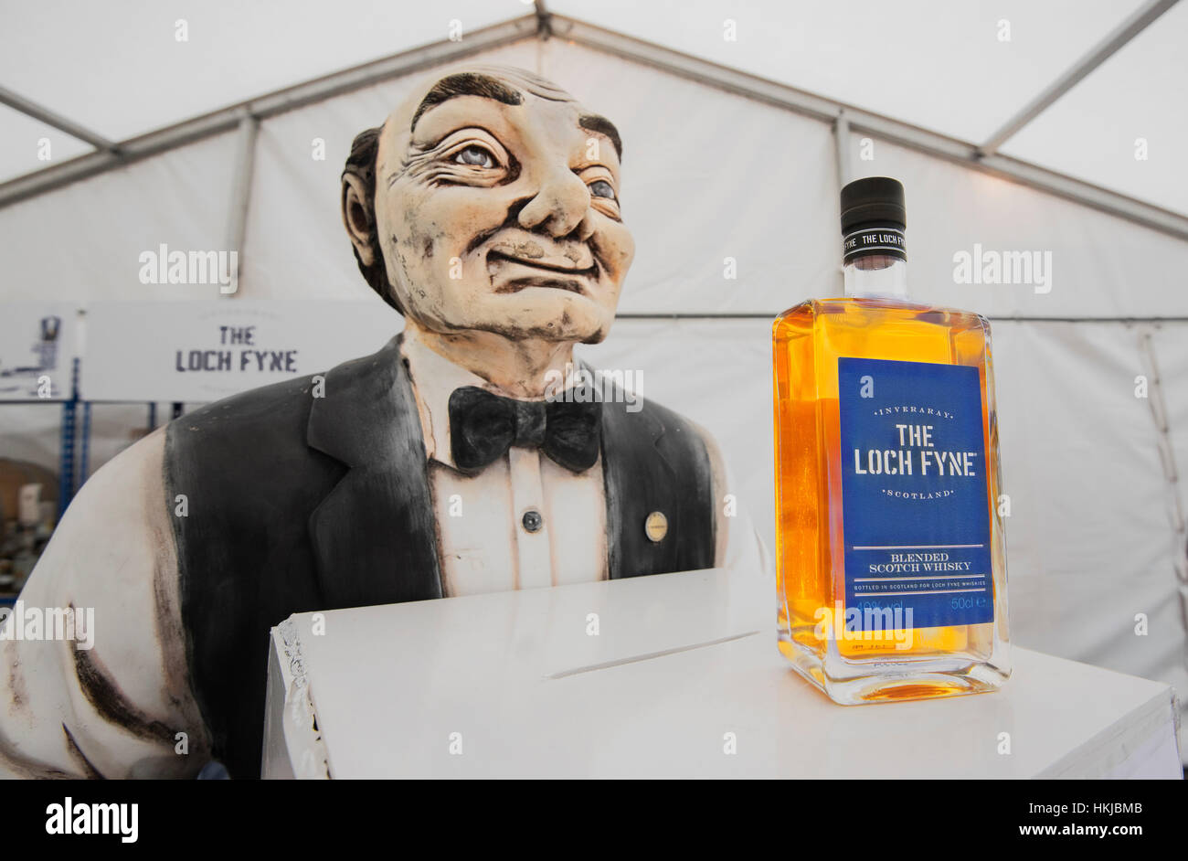 "Hamish" mit einer Flasche feinsten Loch Fyne Whisky. Stockfoto