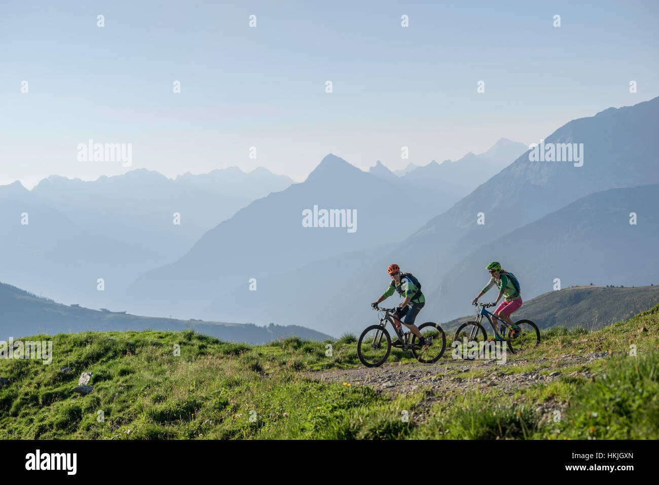 Zwei Mountain-Biker-Freunde fahren bergauf, Zillertal, Tirol, Österreich Stockfoto