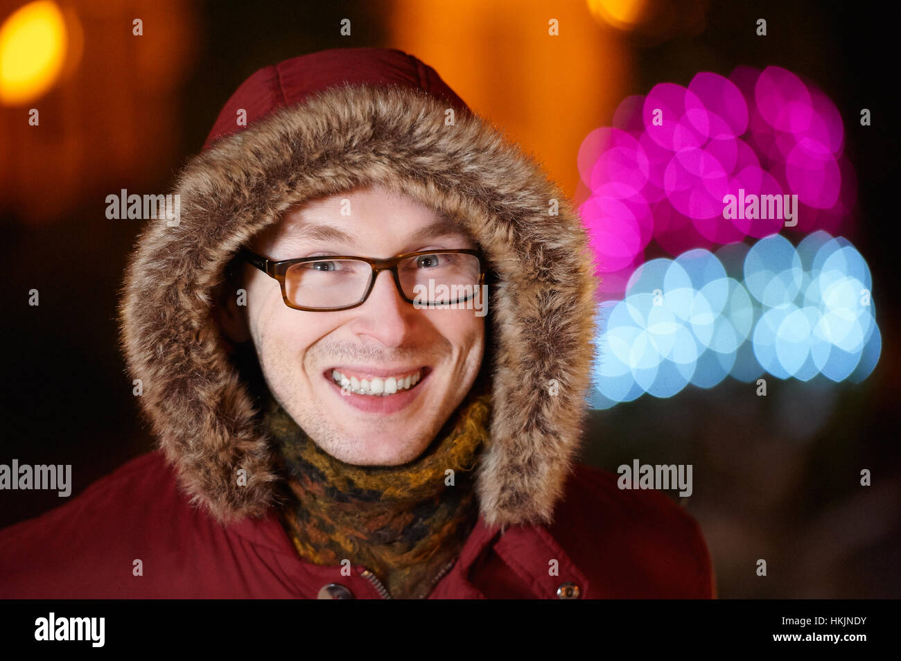 Lächeln Sie, Mann mit Brille im Winterjacke und Schal Stockfoto