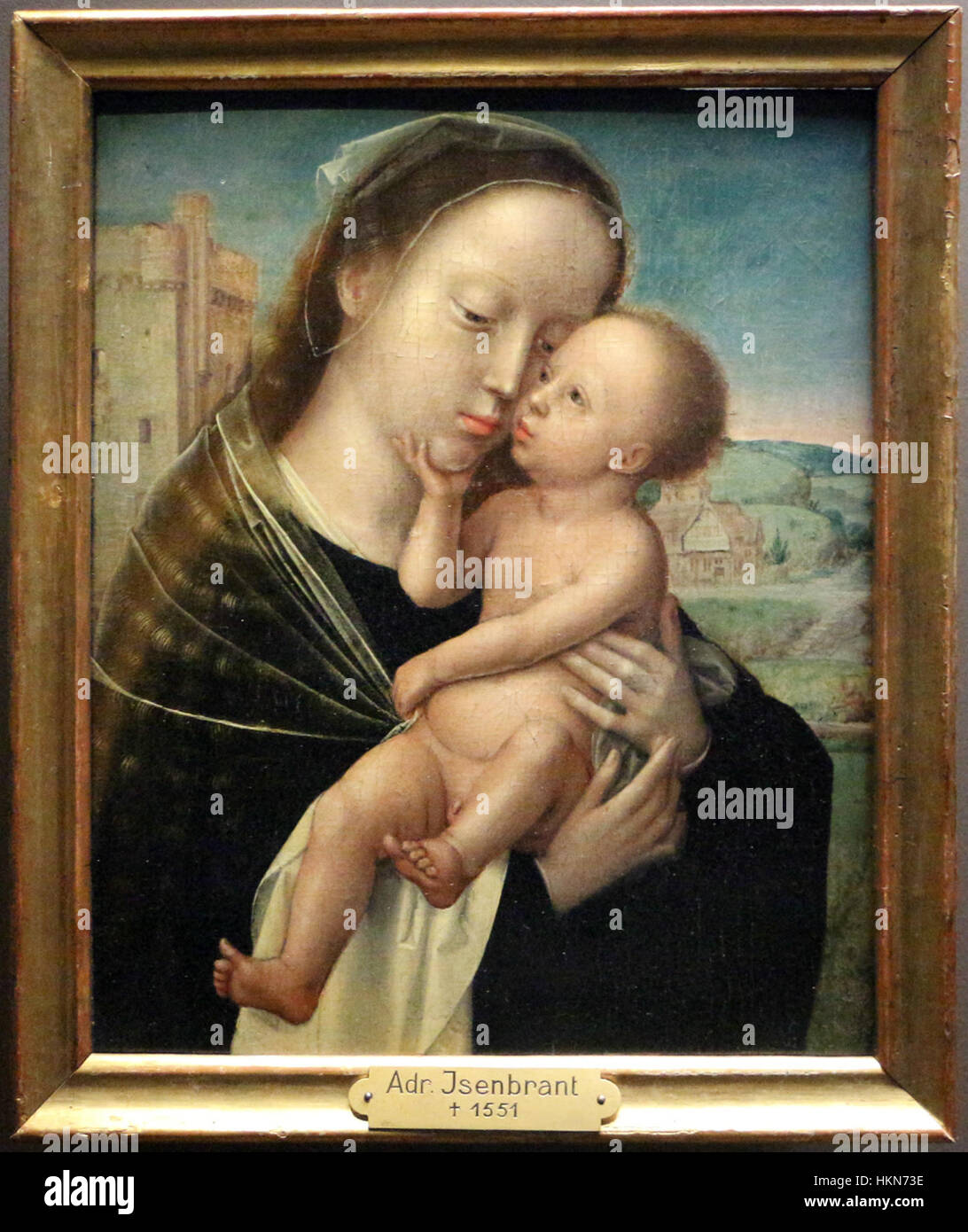 Ein religiöses Ölgemälde von Adriaen Isenbrandt mit dem Titel „Madonna mit Kind“ aus der Zeit um 1520. Diese klassische Darstellung der Jungfrau Maria und des Christuskindes ist detailreich dargestellt und charakteristisch für die Kunst der flämischen Renaissance. Stockfoto