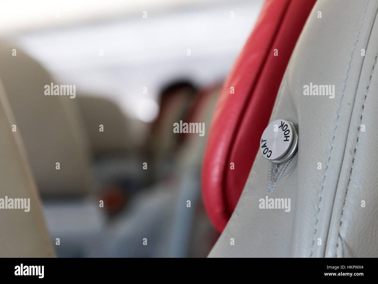 leere Kleiderbügel auf Sitz in einem fliegenden Flugzeug Stockfoto