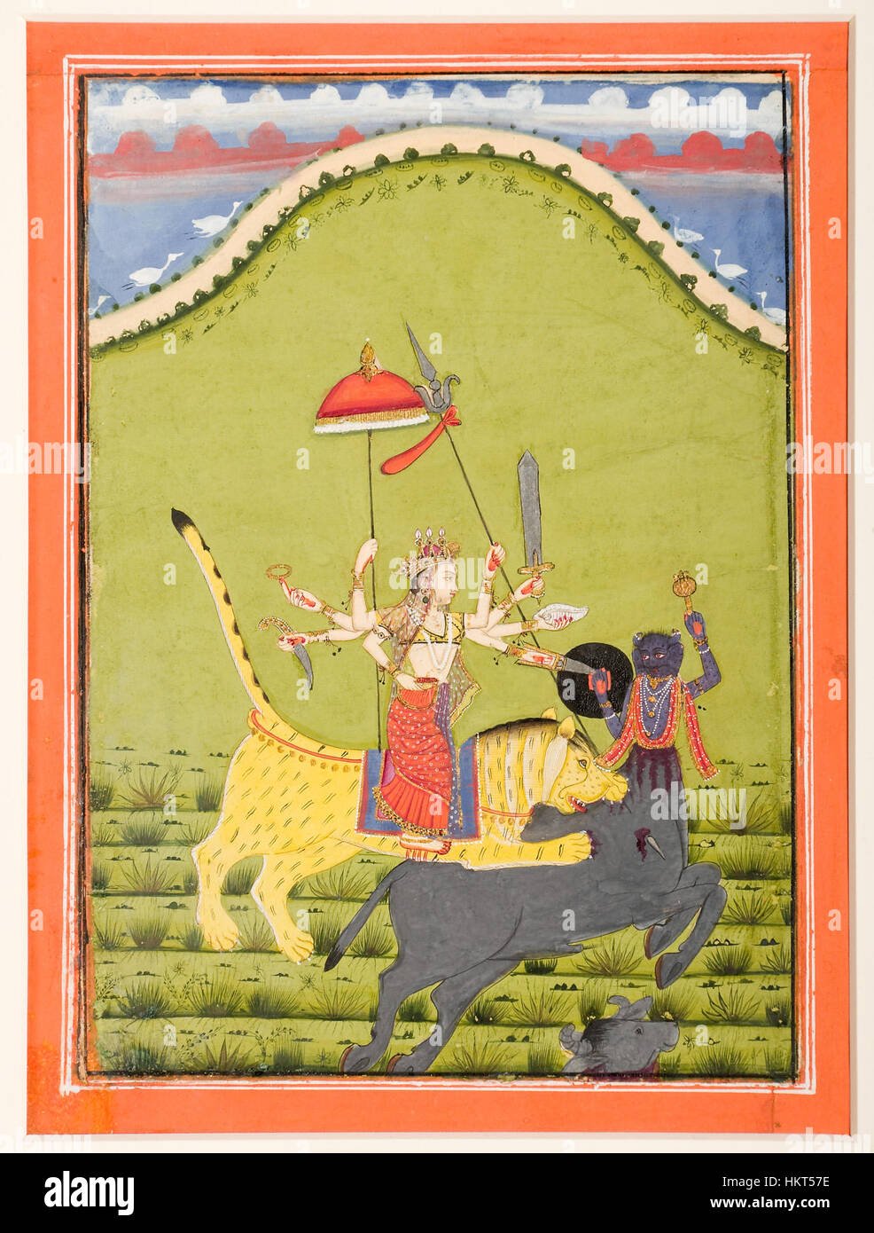 Dieses Kunstwerk zeigt die hinduistische Göttin Durga, die auf einem Tiger reitet und den Büffeldämon Mahisha tötet. Es stellt einen mächtigen Moment aus der hinduistischen Mythologie dar, der den Triumph des Guten über das Böse symbolisiert. Stockfoto