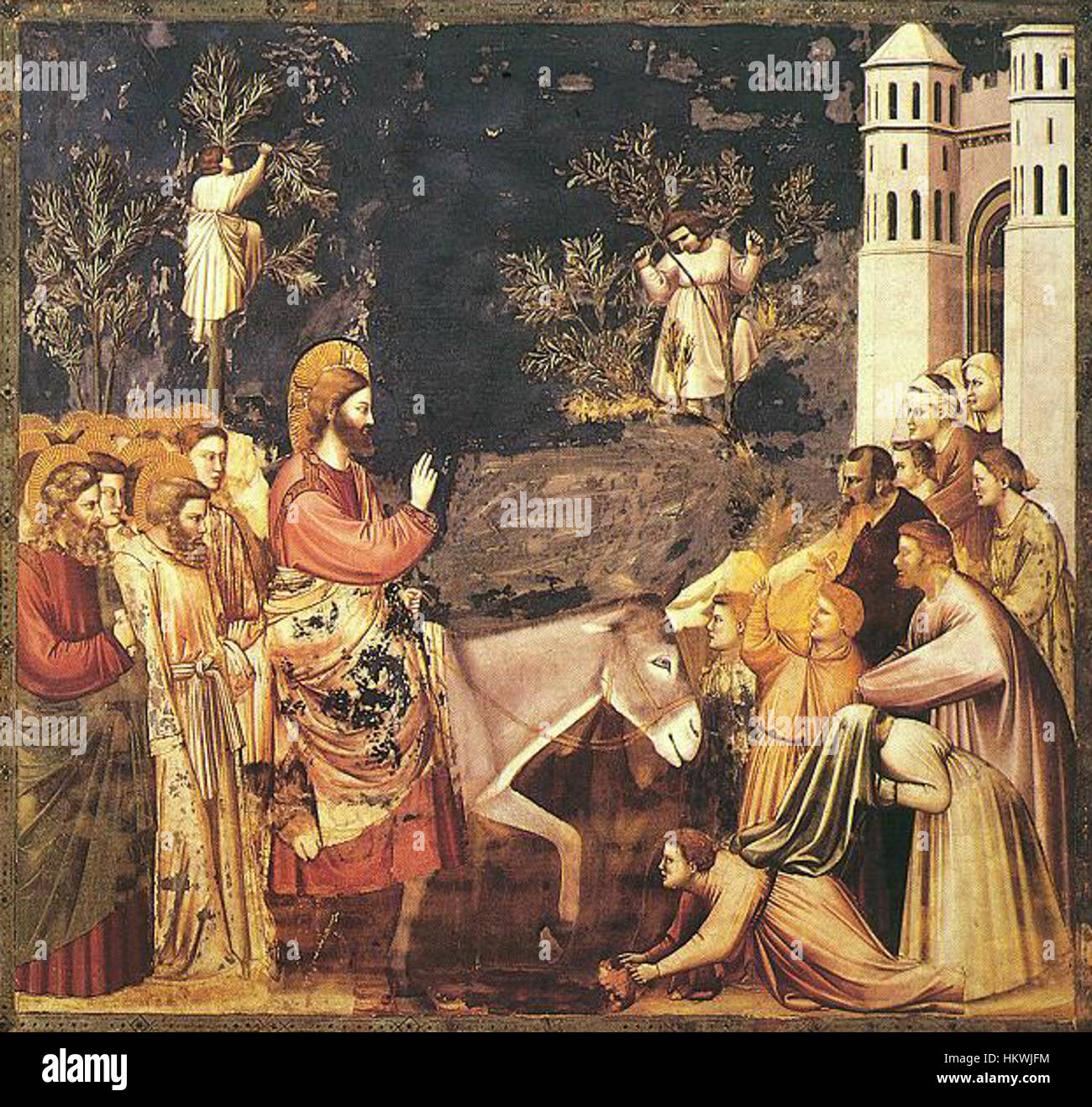 Ein Fresko von Giotto, Teil des Zyklus der Scrovegni-Kapelle, das die biblische Szene des triumphalen Eintritts Christi in Jerusalem darstellt. Dieses Meisterwerk fängt den emotionalen und dramatischen Moment in lebendigen Farben und Formen ein. Stockfoto