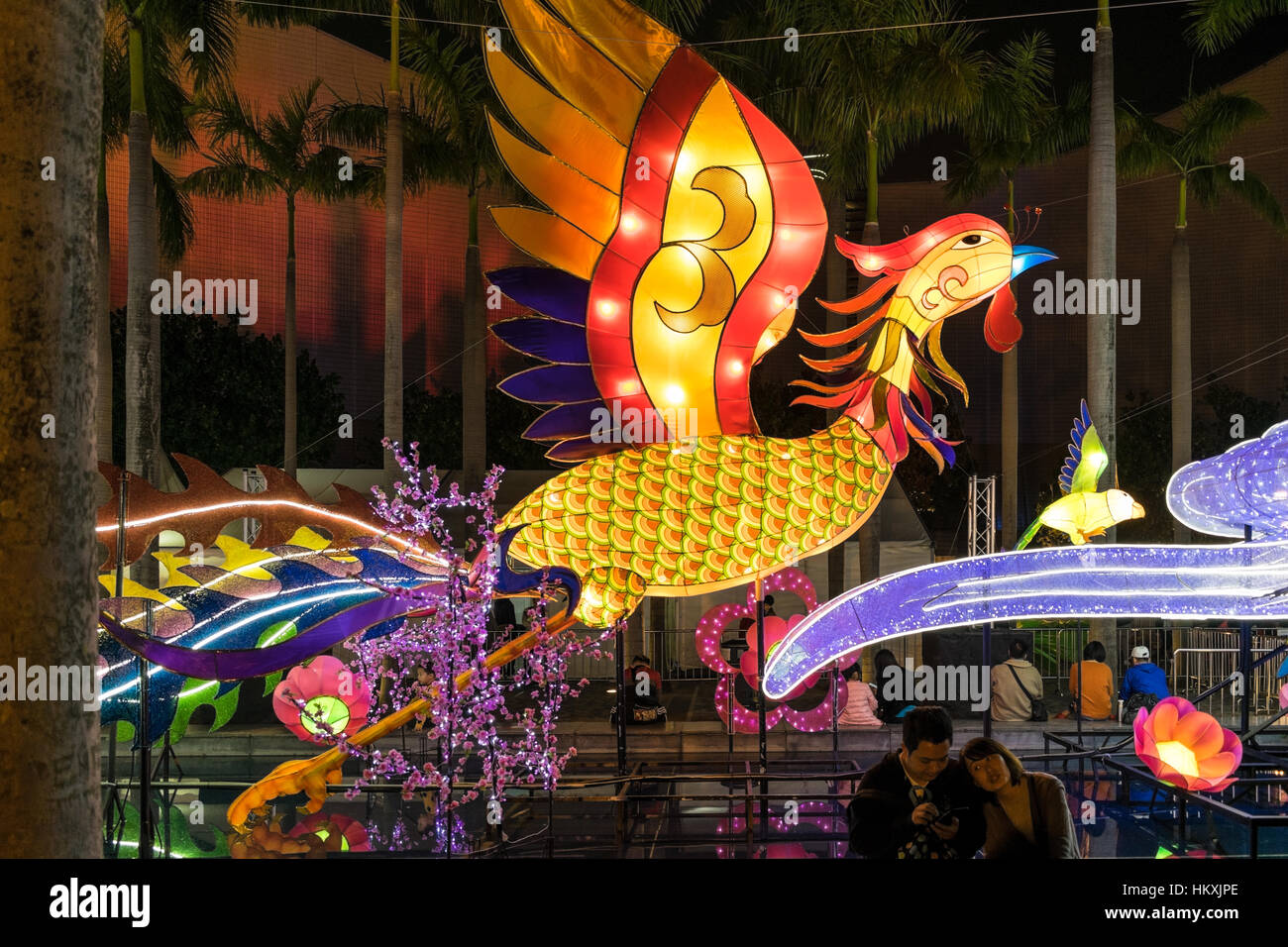 Riesige Hahn Laterne Anzeige an das chinesische Neujahr 2017 "Jahr des Hahns" Feier mit jungen asiatischen Paar in Tsim Sha Tsui, Hong Kong. Stockfoto