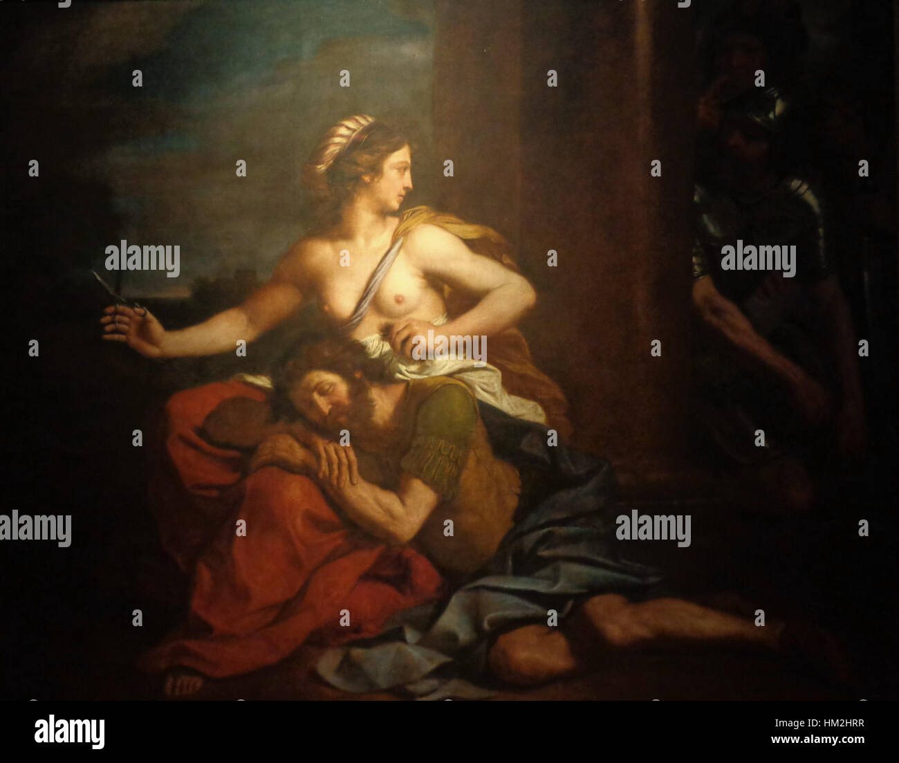 Guercinos „Samson und Delilah“ veranschaulicht den dramatischen Moment aus der biblischen Geschichte und erfasst die Verletzlichkeit und den Verrat Samsons. Das barocke Gemälde ist bekannt für seine reiche Verwendung von Licht und Schatten, die die emotionale Tiefe der Figuren darstellen. Stockfoto