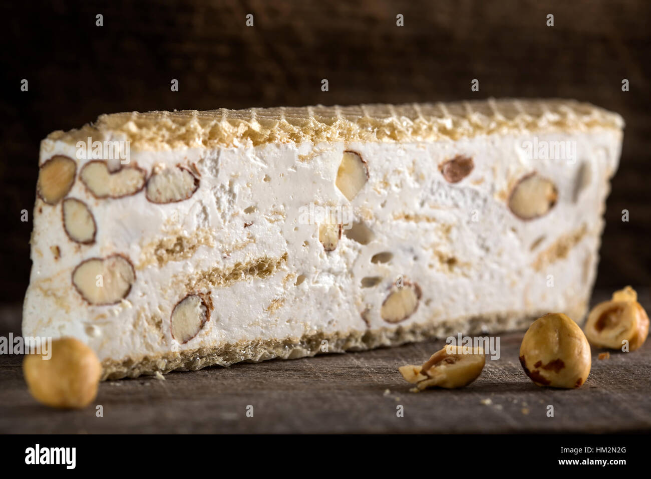 Nahaufnahme von Torrone oder Nougat mit Nüssen auf Holz Hintergrund Stockfoto