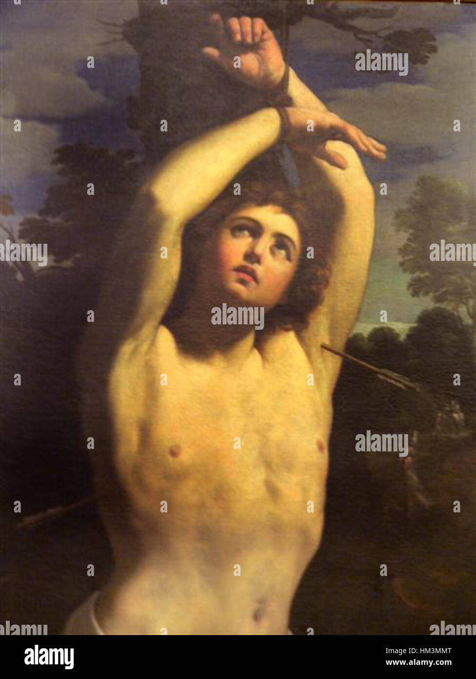 Guido Renis Gemälde von St. Sebastian, hier in einer detaillierten Nahaufnahme, zeigt das Martyrium des heiligen und zeigt Renis barocken Stil und Meisterschaft in der religiösen Ikonographie. Stockfoto