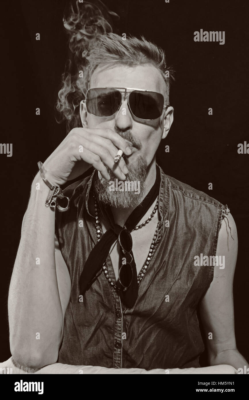 Porträt des jungen Mann mit Zigarette mit einer Sonnenbrille Stockfoto