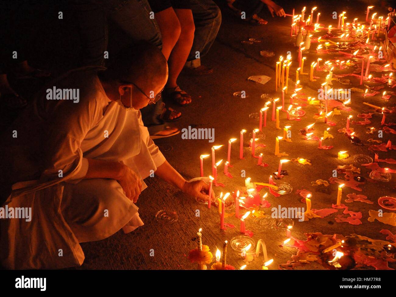 Thailand, Bangkok, einem weiblichen Mönch Anzünden einer Kerze zum Gedenken  an König Bhumibol Adulyadej Geburtstag Stockfotografie - Alamy