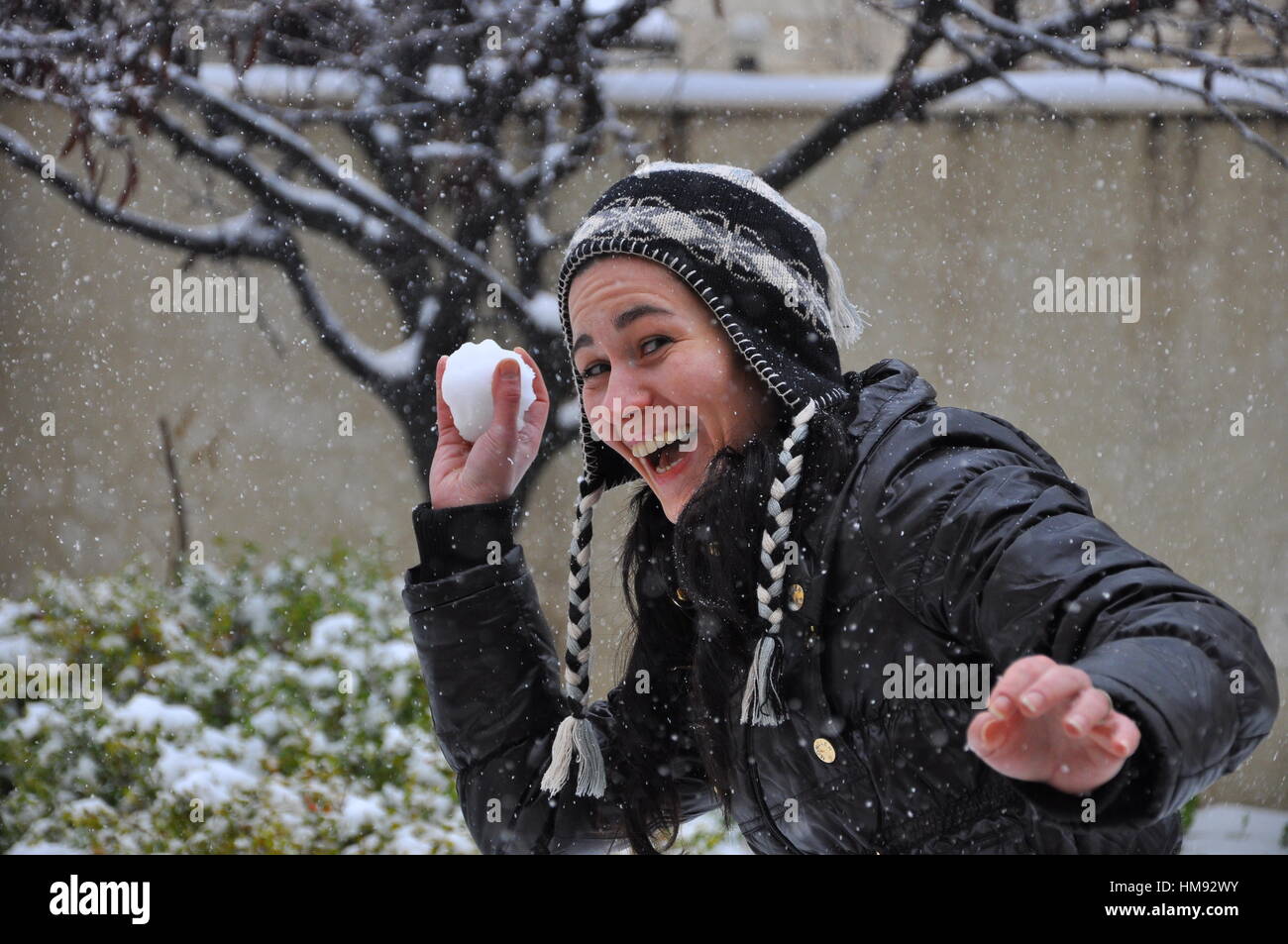 Schnee zu kämpfen, Frau spielt mit Schneeball Stockfoto