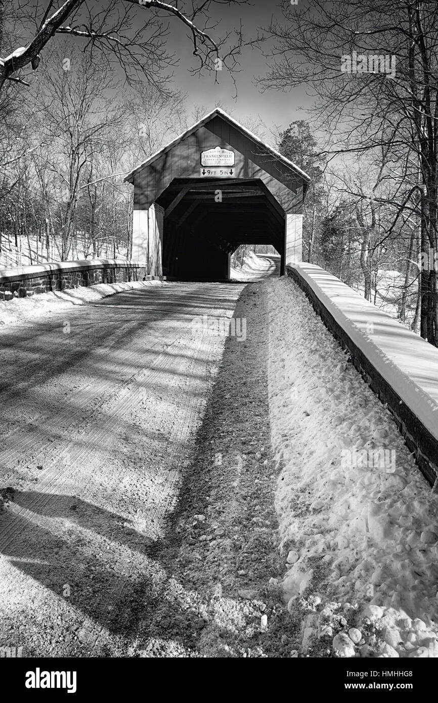 Niedrigen Winkel Blick auf die historischen Frankfield bedeckte Brücke im Winter über Tinicum Creek, Bucks County, Pennsylvania Stockfoto