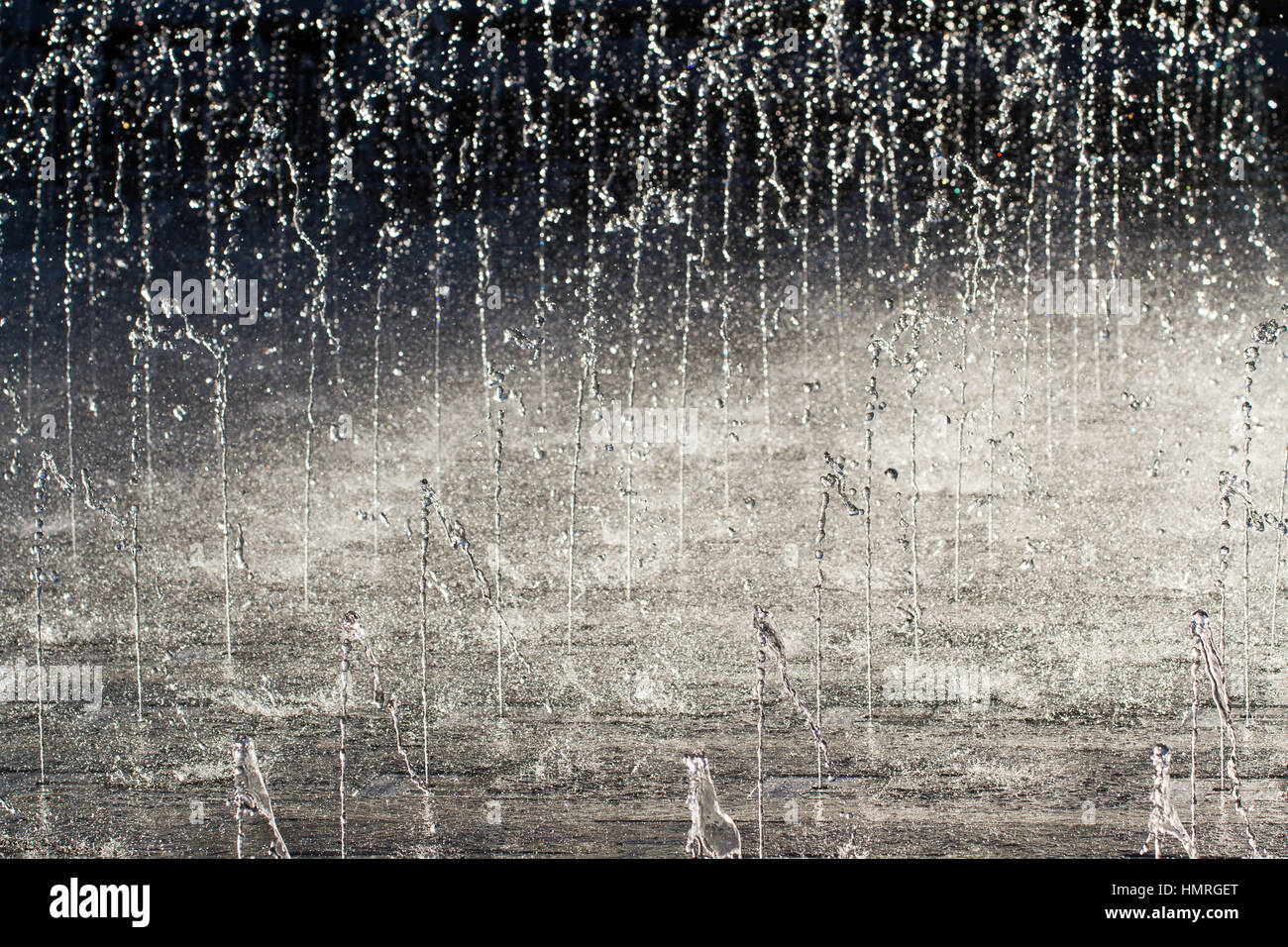 Jets von kaltem, klaren Wasser nach oben spritzt und spritzt auf den Boden in einen hohen Kontrast, full-Frame-Hintergrundbild. Stockfoto