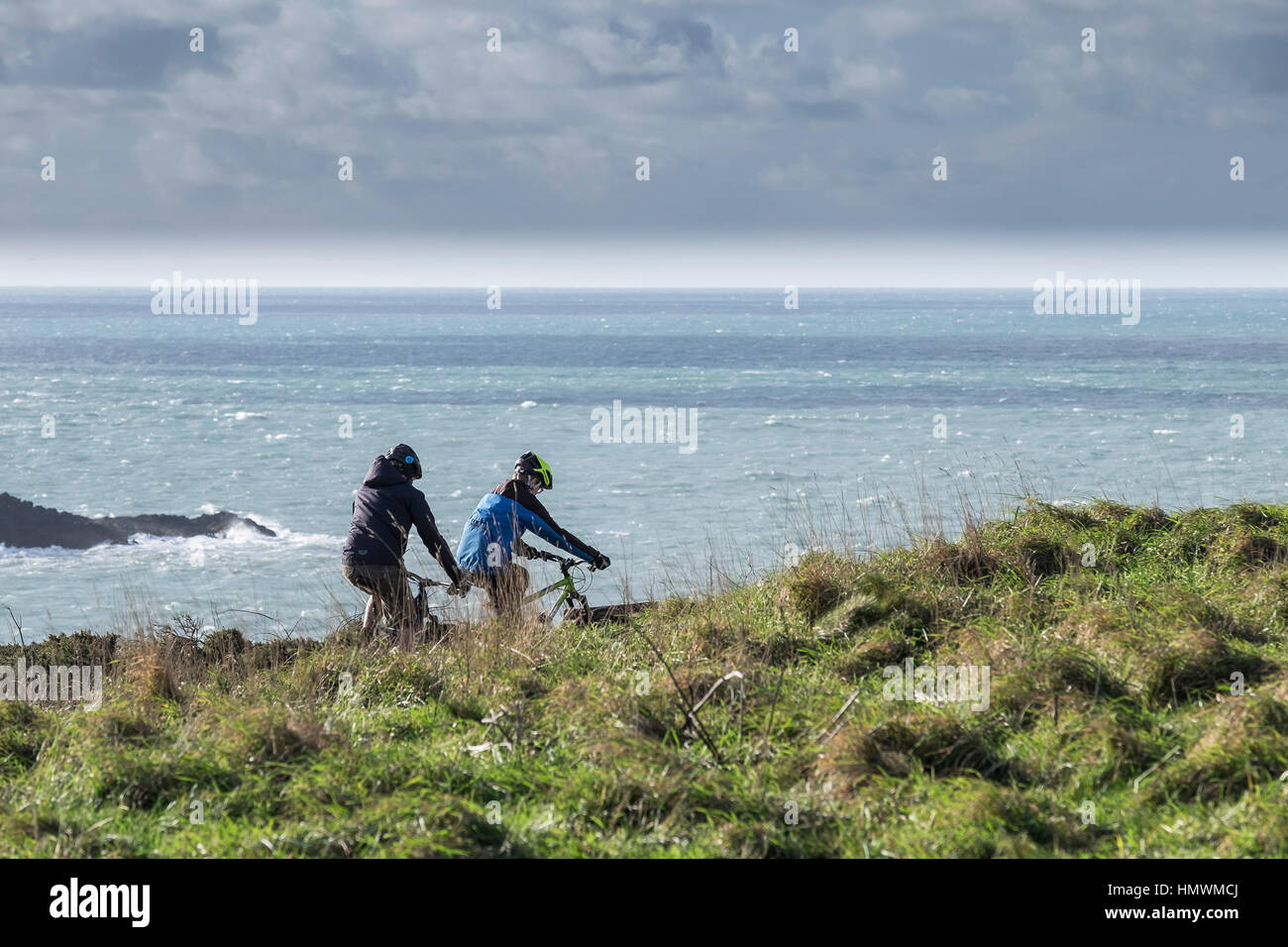 Zwei Radfahrer auf dem Küstenpfad auf Osten Pentire Landzunge in Newquay, Cornwall. Stockfoto