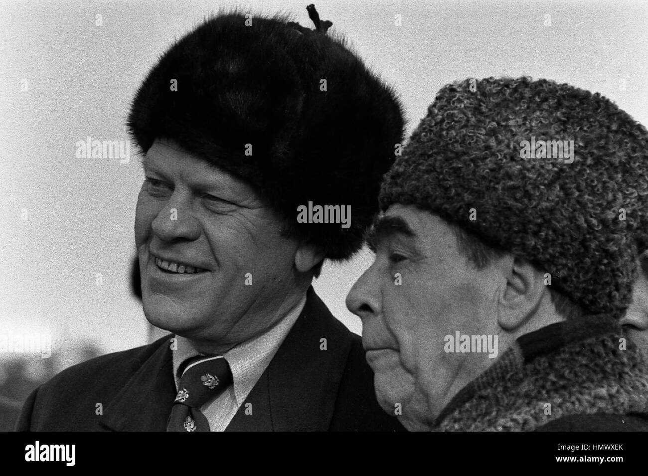 US-Präsident Gerald Ford ein Russe tragen Pelz Hut mit sowjetischen Generalsekretär Leonid Brezhnev bei der Ankunft am lang Airbase 23. November 1974 in Wladiwostok, Russland, UdSSR. Ford ist in Wladiwostok zu einem zweitägigen Gipfel über Rüstungskontrolle. Stockfoto