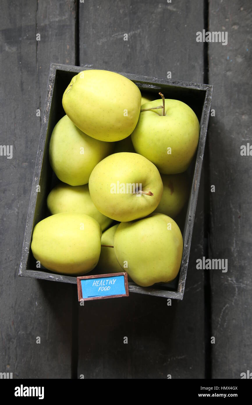 gesunde Ernährung-Konzept - Text und frische Äpfel auf einem schwarzen Tisch Stockfoto