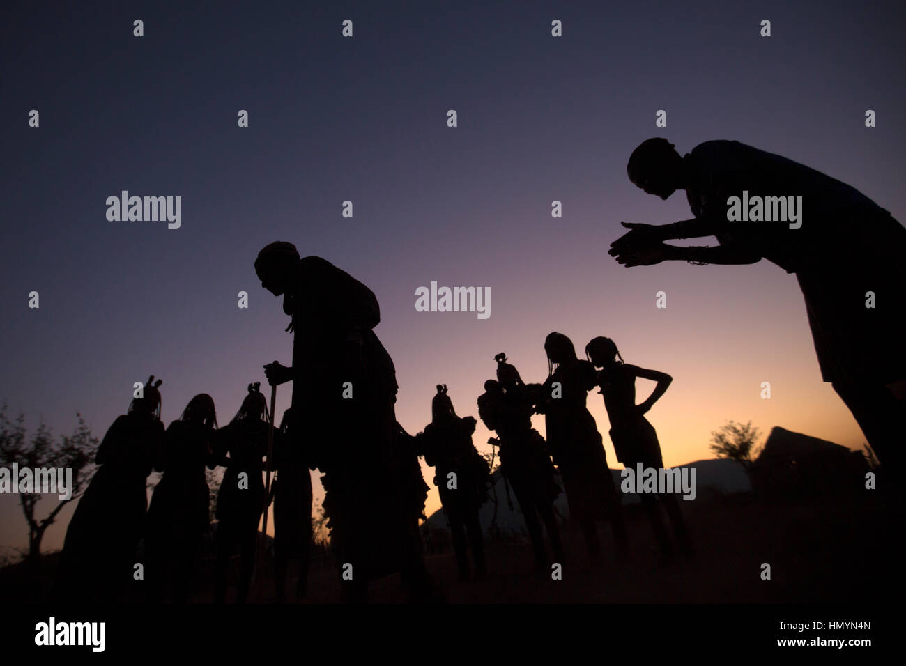 Himba Dorfbewohner Tanz in der Abenddämmerung in Namibia. Stockfoto