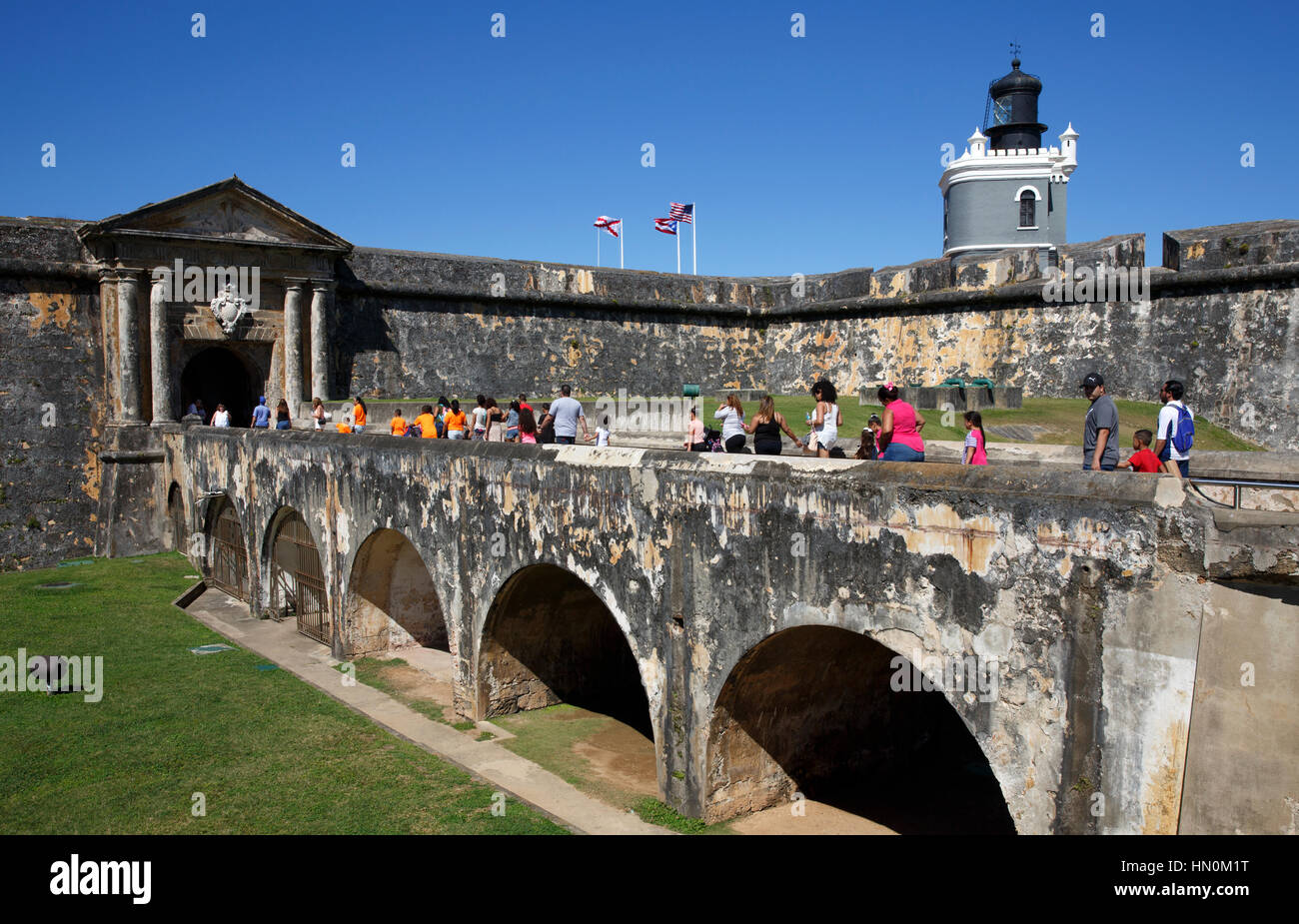 Menschen überqueren Sie eine Brücke zum Eingang des historischen San Felipe del Morro Festung in San Juan, Puerto Rico Stockfoto