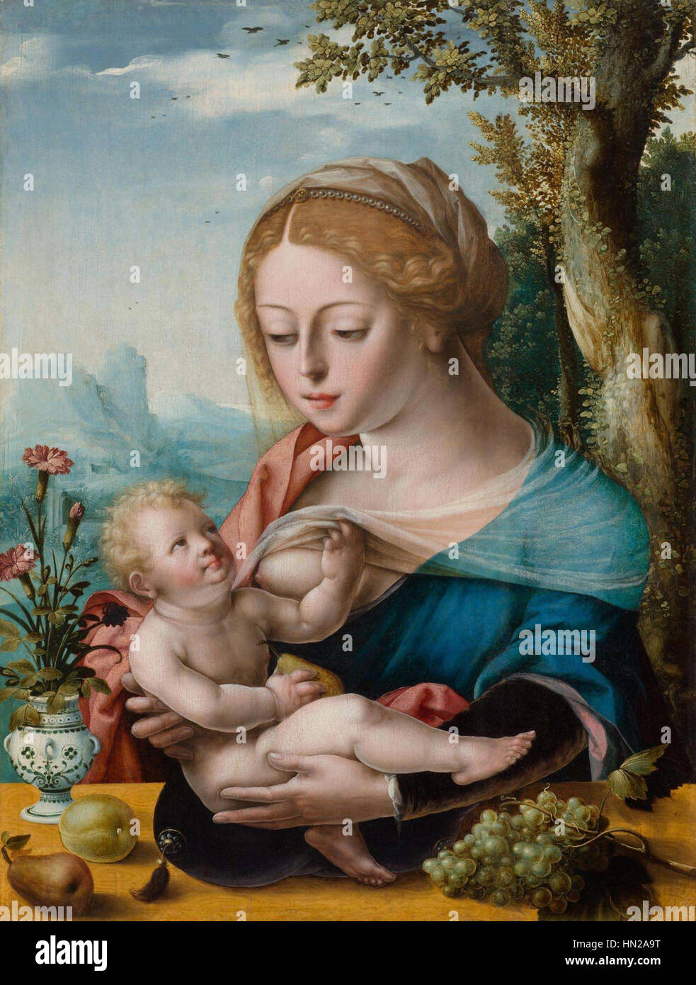 Dieses Kunstwerk zeigt die Jungfrau Maria mit dem Christkind und einem Papagei. Die Symbolik des Papageiens steht im Gegensatz zur heiligen Natur der Figuren und fügt dem religiösen Thema eine Bedeutungsebene hinzu. Die Darstellung betont Unschuld, Reinheit und göttliche Pflege, wobei der Papagei Schönheit und Exotik im Kontext religiöser Kunst symbolisiert. Stockfoto