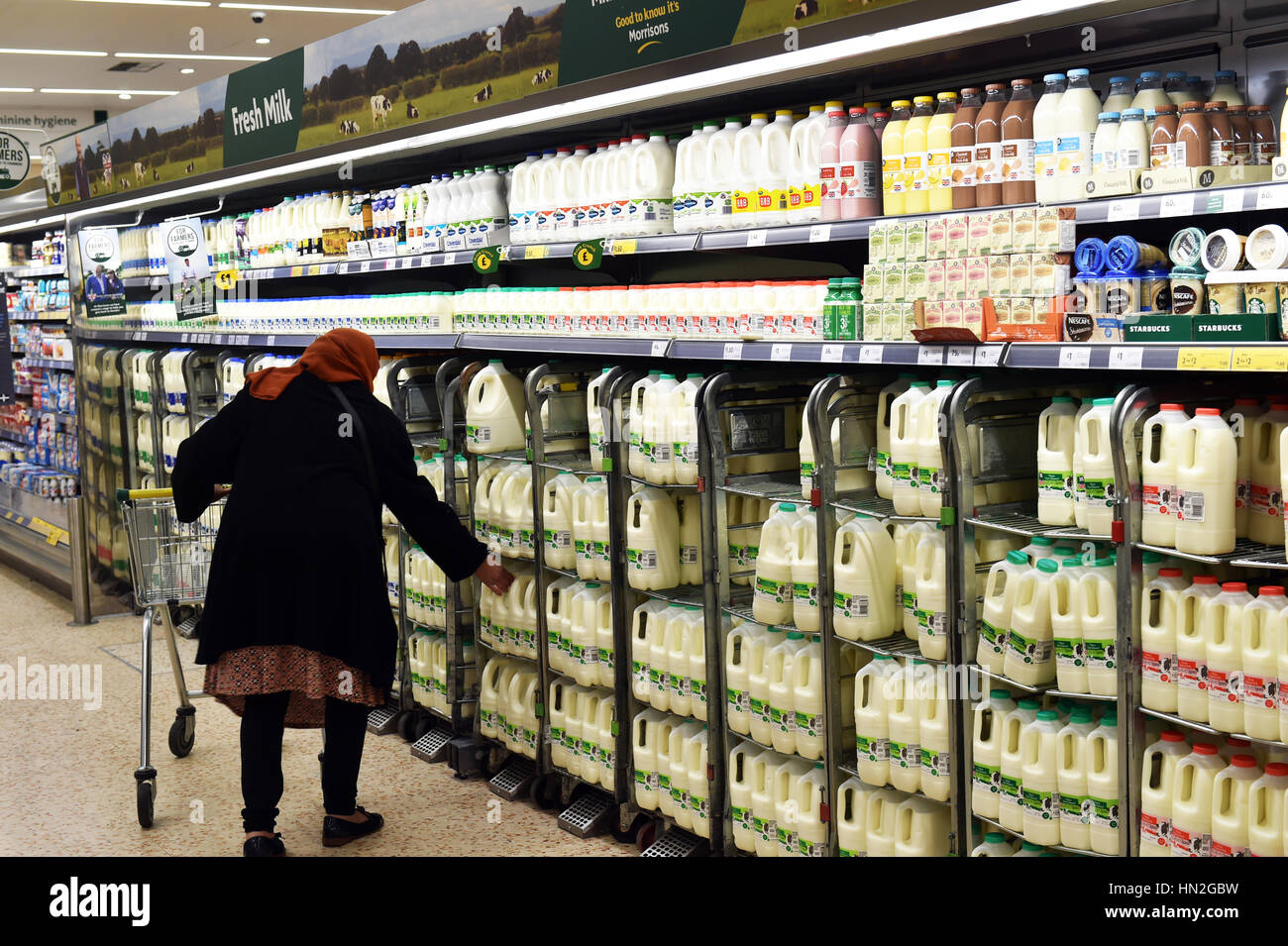 Frau kauft Milch aus dem Supermarkt UK Stockfoto