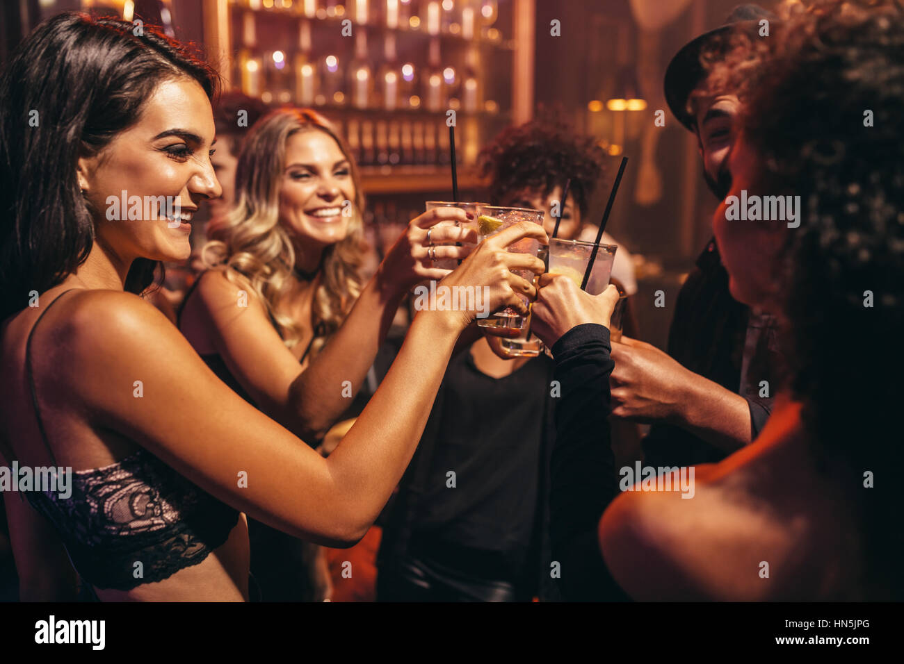 Gruppe von Jugendlichen mit Cocktails im Nachtclub. Beste Freunde Party in einer Kneipe und Toasten Getränke. Stockfoto