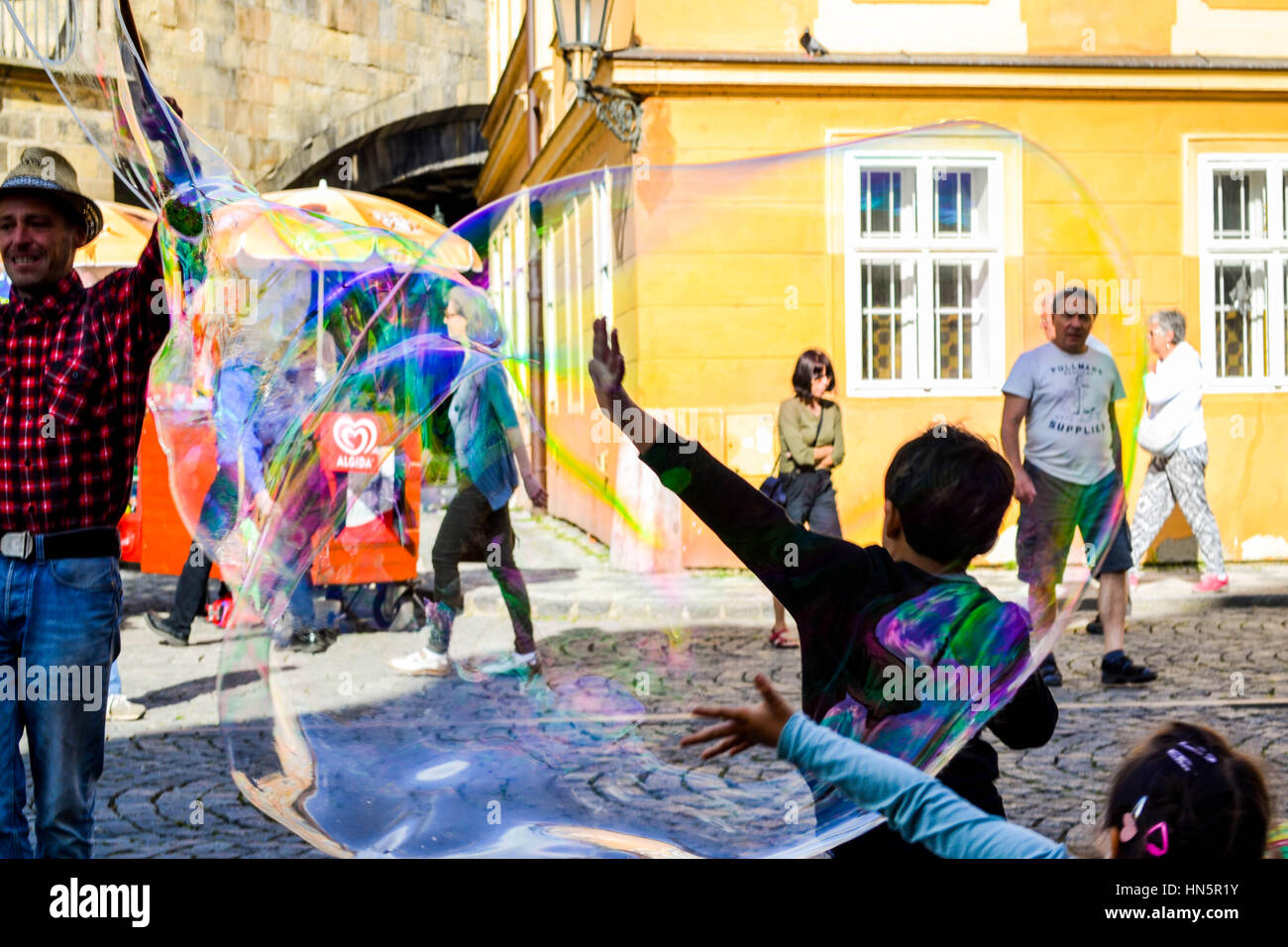 Kinder spielen mit Luftblasen in Prag Stockfoto