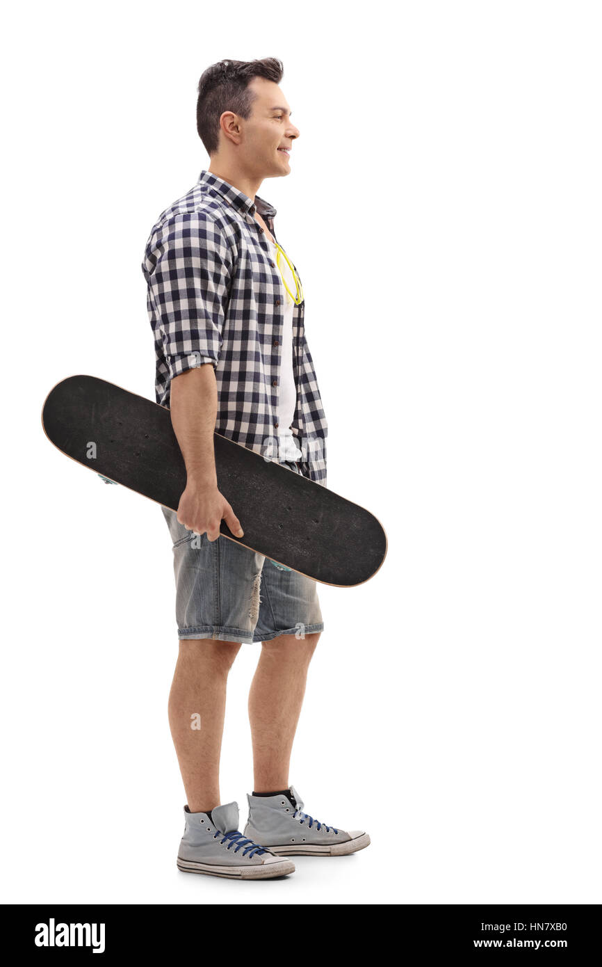 Voller Länge Profil Schuss ein Skater hält eine Skateboard und in der Schlange isoliert auf weißem Hintergrund Stockfoto