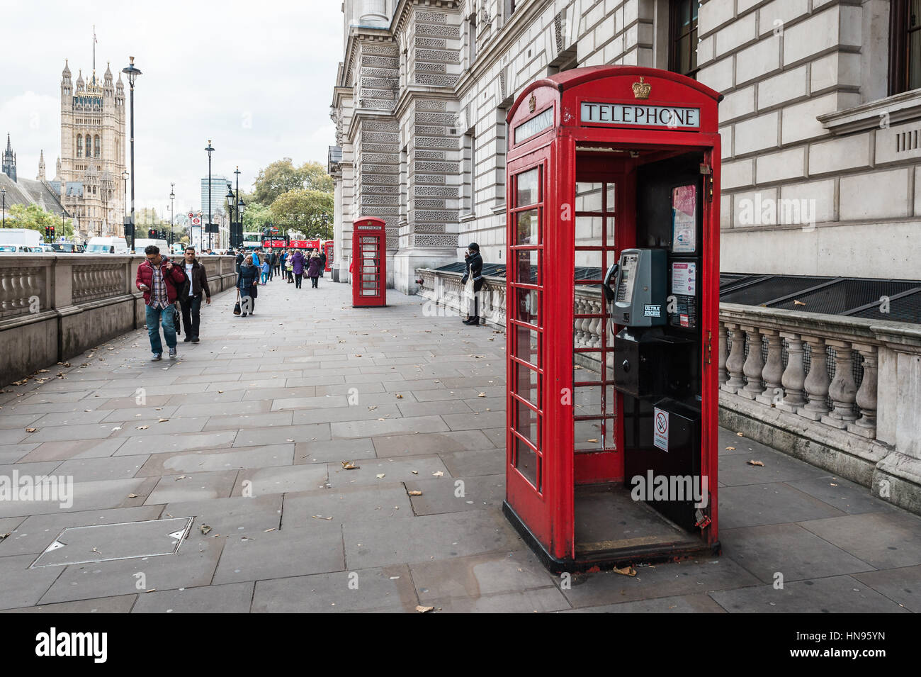 London, Vereinigtes Königreich - 20. Oktober 2016: Menschen sind auf der Straße neben der roten Telefonzelle in London Fuß. Stockfoto