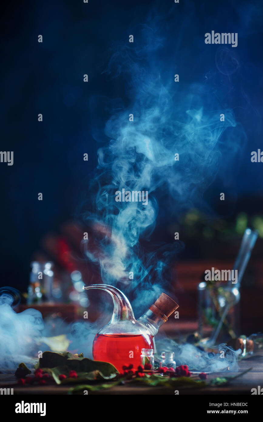 Labor Retorte mit roten Flüssigkeit und Dicke Rauchwolken steigende auf dunkelblauem Hintergrund Stockfoto