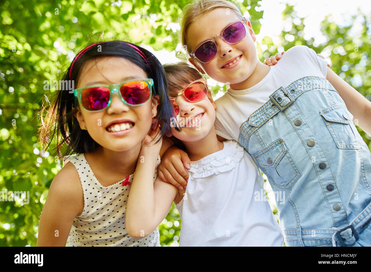 Drei Mädchen haben Spaß zusammen mit Sonnenbrille im Sommer als Freunde Stockfoto