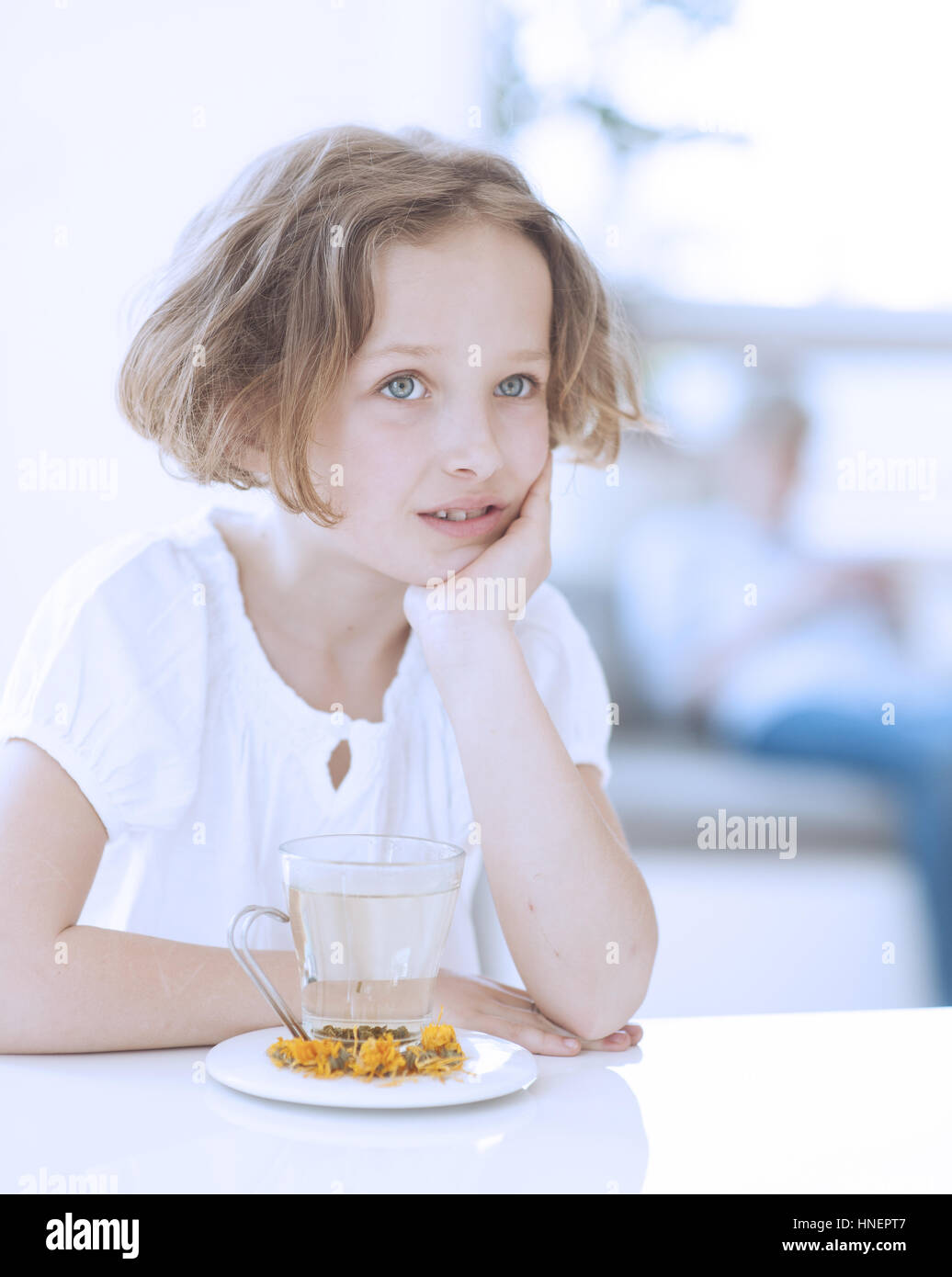 Junges Mädchen mit Tasse Tee und Blumen Stockfoto
