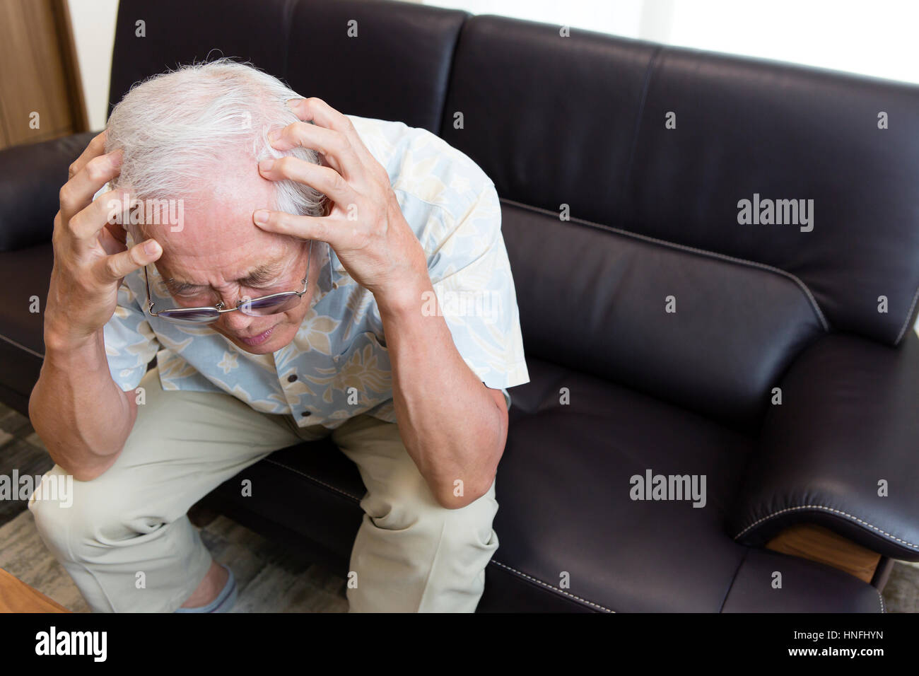 Ein senior Mann mit Kopfschmerzen Stockfoto