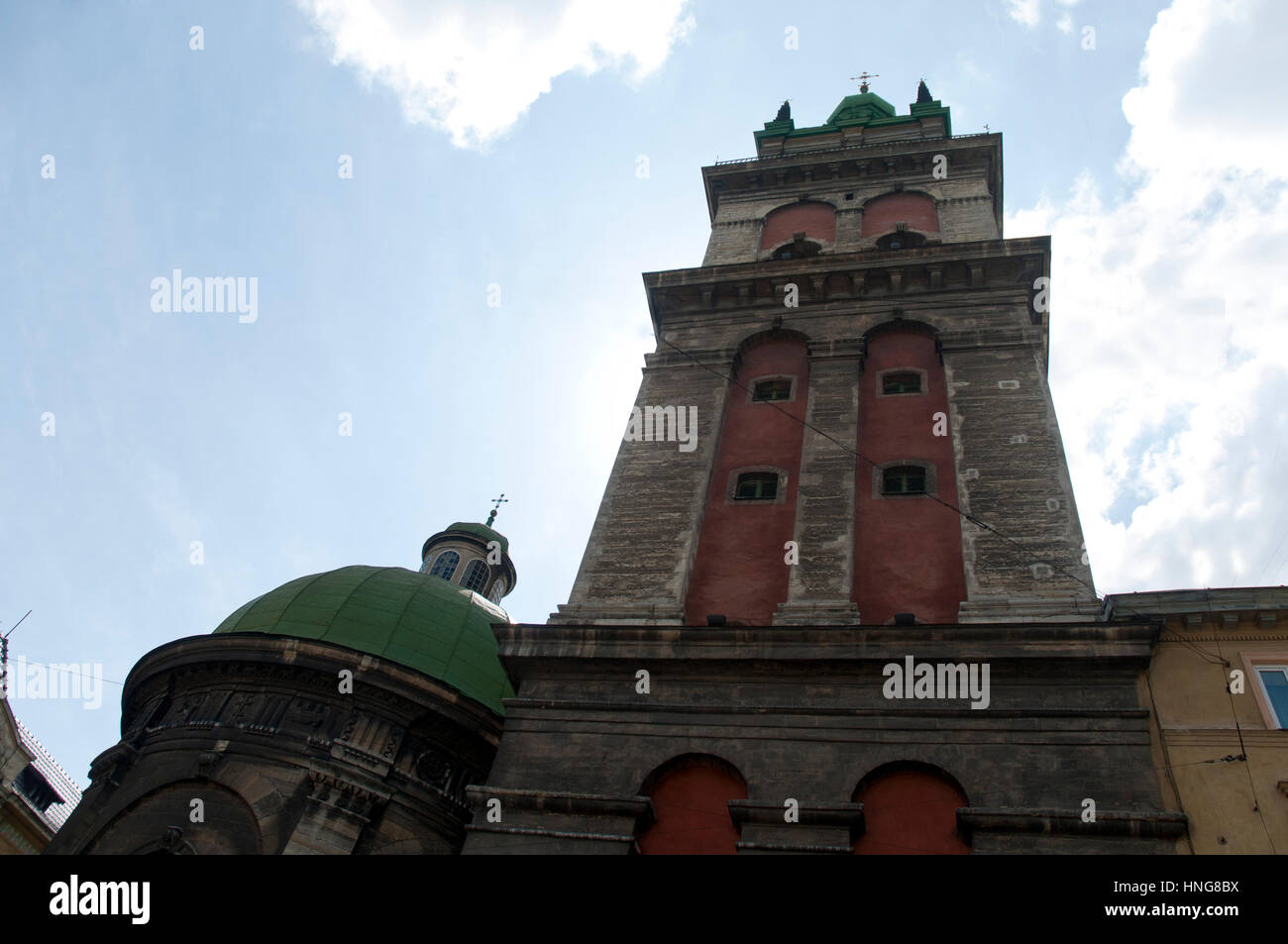 Historischer Kirchturm mit roter Fassade – architektonischer Blick aus der Altstadt von Lemberg Stockfoto