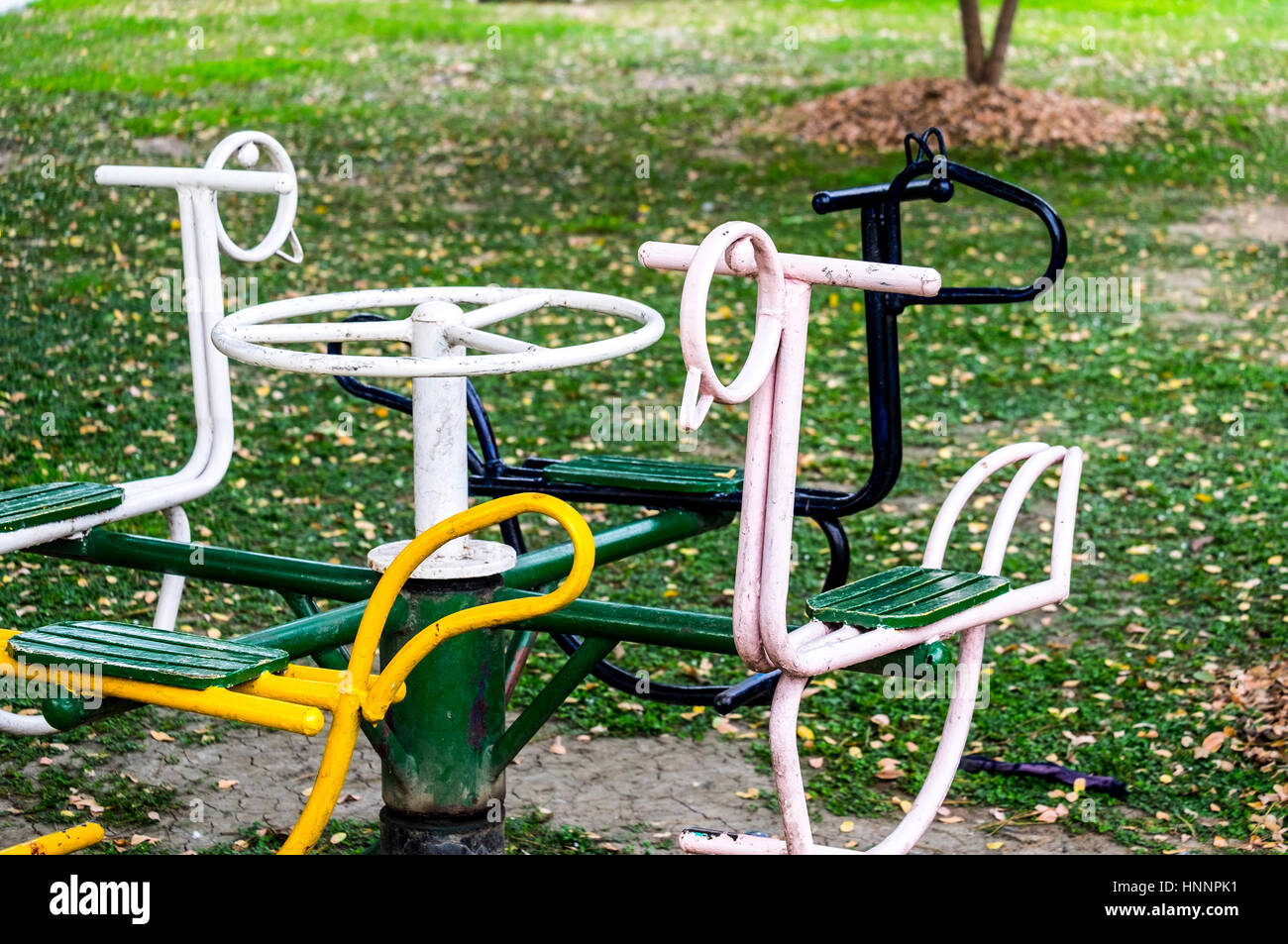 Altes Karussell für 4 Kindersitze auf dem Spielplatz, front Fokus verschwommen Hintergrund Stockfoto