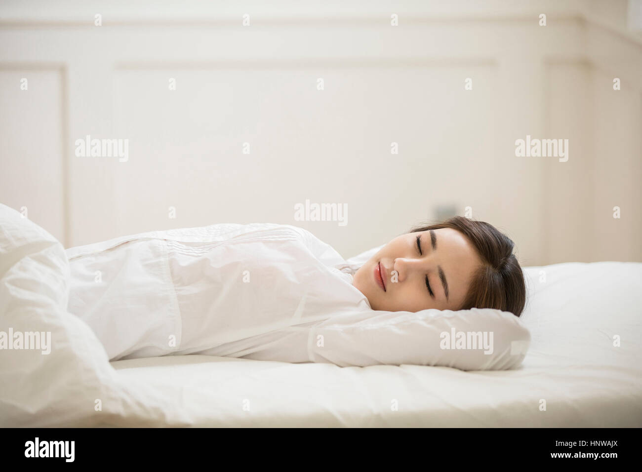 Junge Frau im Bett ruhen Stockfoto