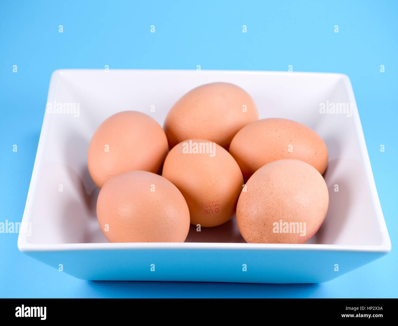 Ein halbes Dutzend Organic Free Range Eiern in eine weiße quadratische Schale Stockfoto