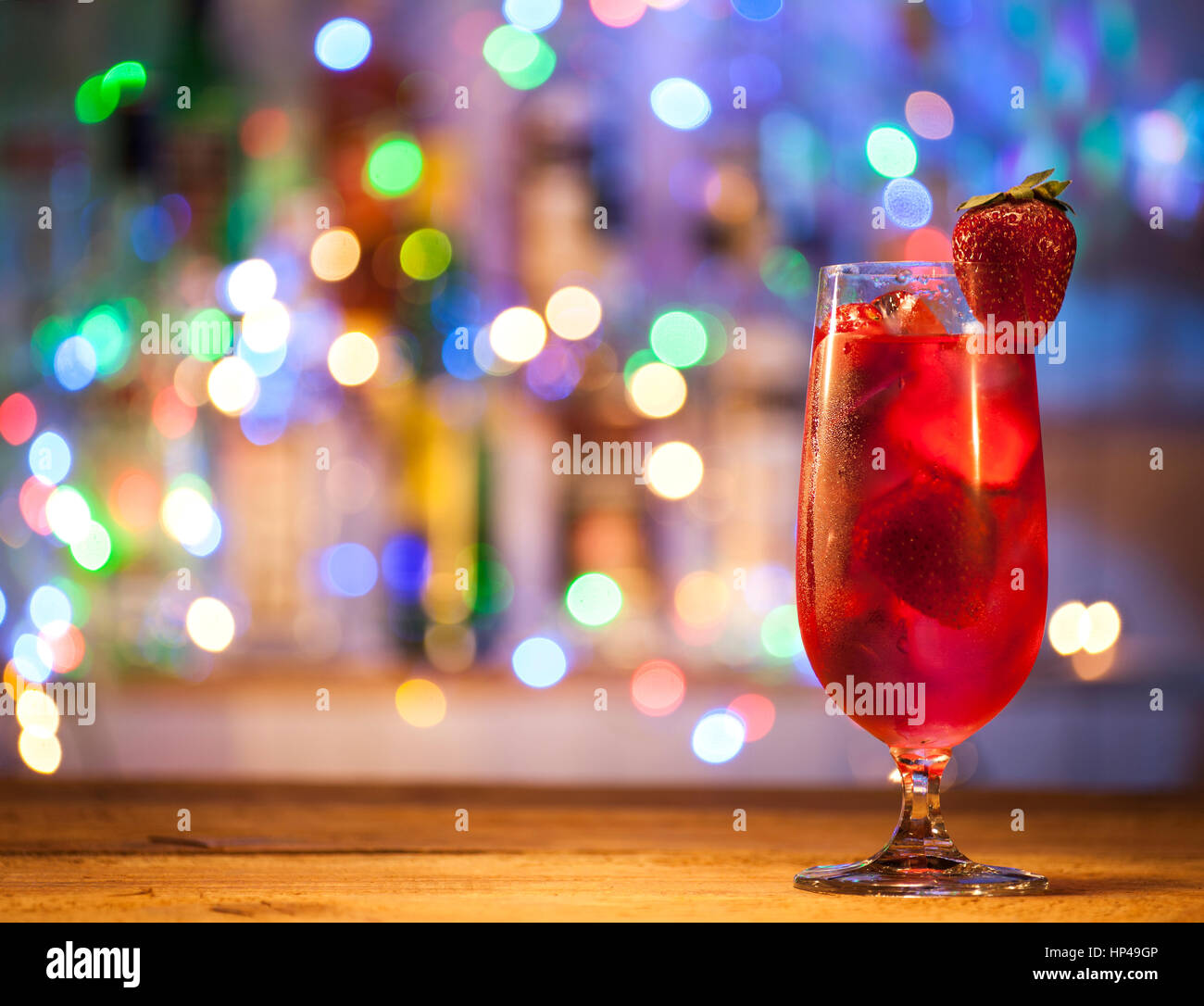 Glas Erdbeer cocktail auf einen Balken leuchtet Hintergrund. Stockfoto