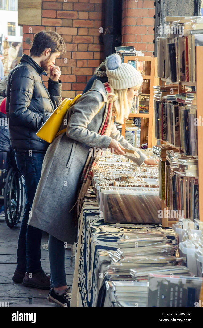 Eine Dame blättert durch Bücher, die zum Verkauf an einem Marktstand in den beiliegenden Gehweg neben Hafen von Bristol in Großbritannien sind. Stockfoto