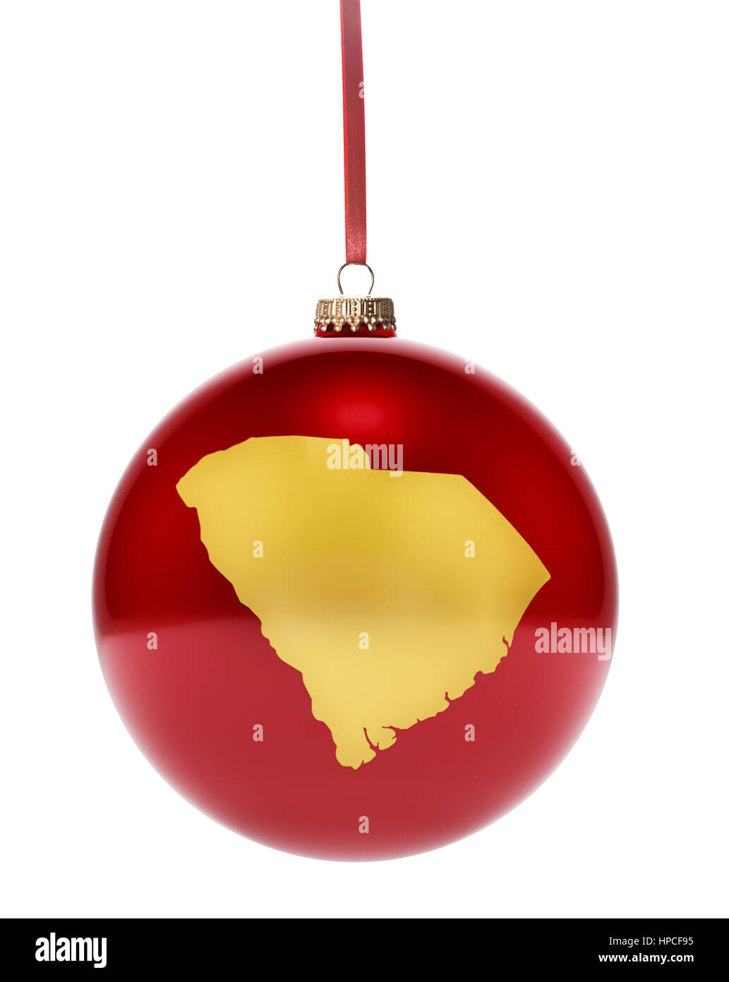 Eine hängende glänzend rote Christbaumkugel mit der goldenen Form von South Carolina. (Serie) Stockfoto