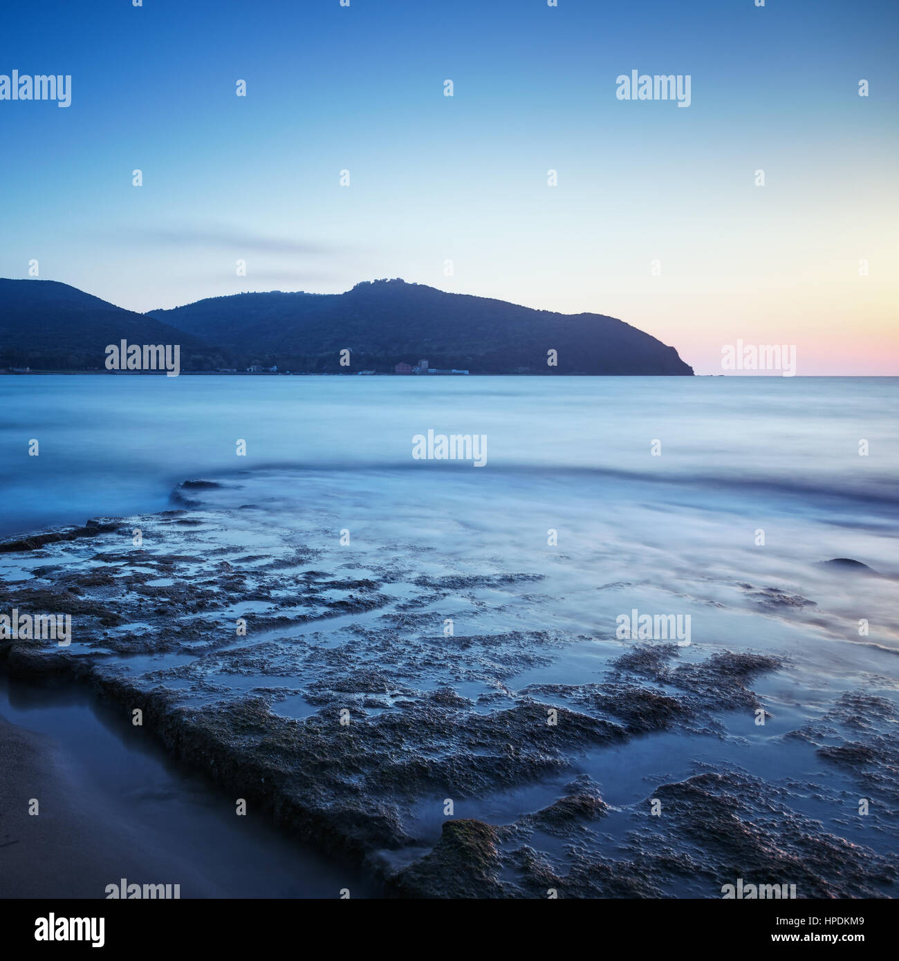 Baratti Bucht, Reiseziel, Landzunge Hügel, Felsen und Meer bei Sonnenuntergang. Toskana, Italien, Europa. Langzeitbelichtung Stockfoto