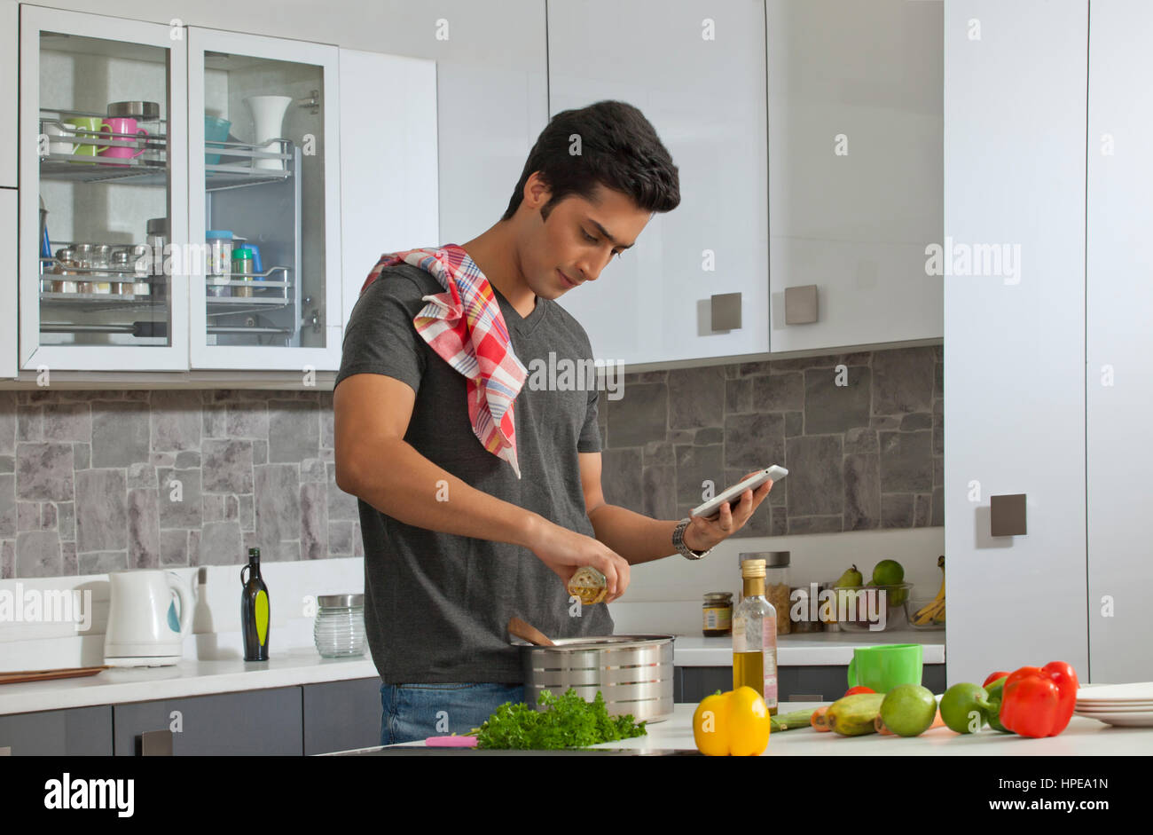 Junger Mann in Küche mit digital-Tablette Stockfoto