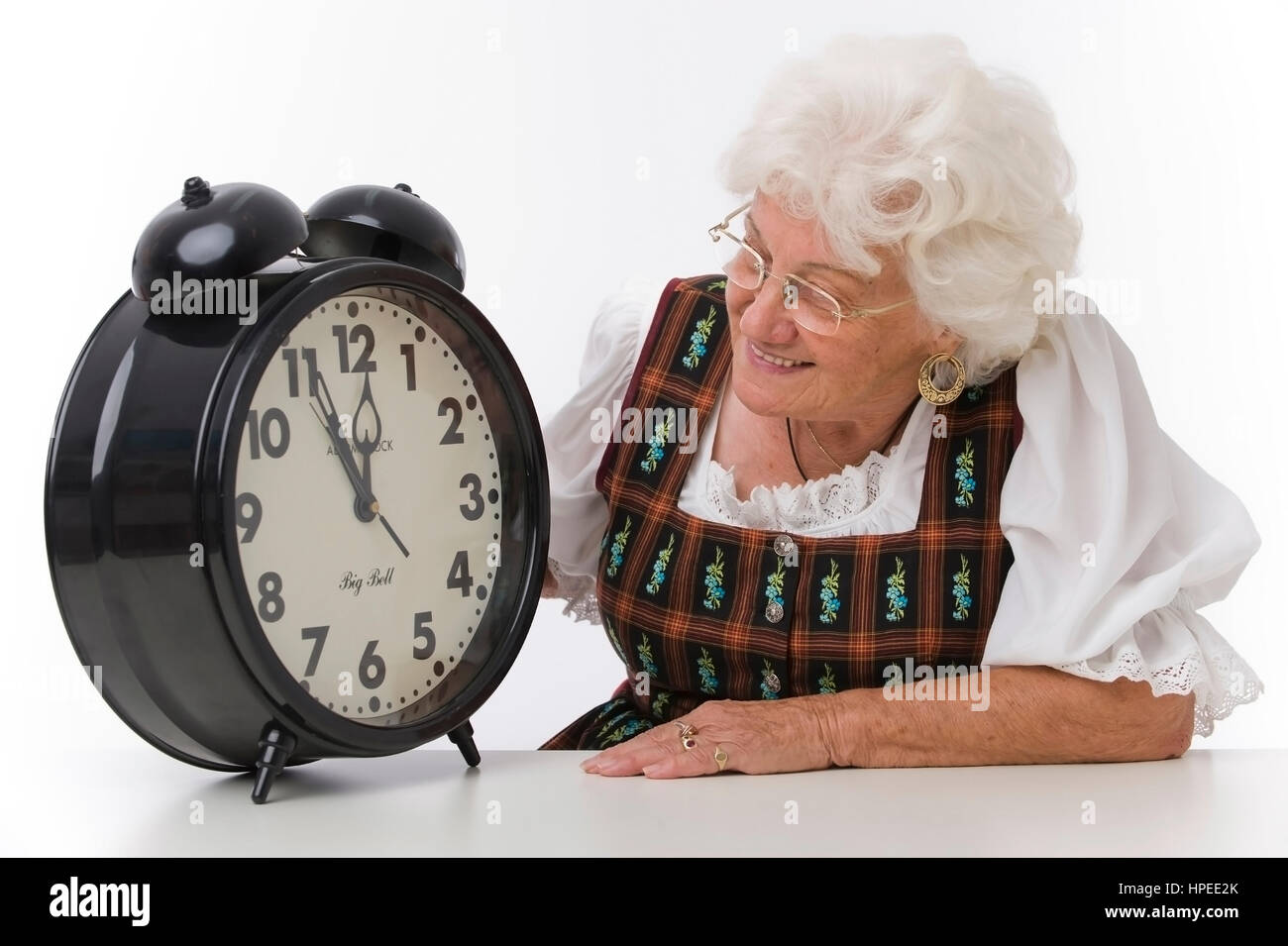 Model Release, 5 Vor 12, Seniorin Mit Wecker - die elfte Stunde, Frau mit Wecker Stockfoto