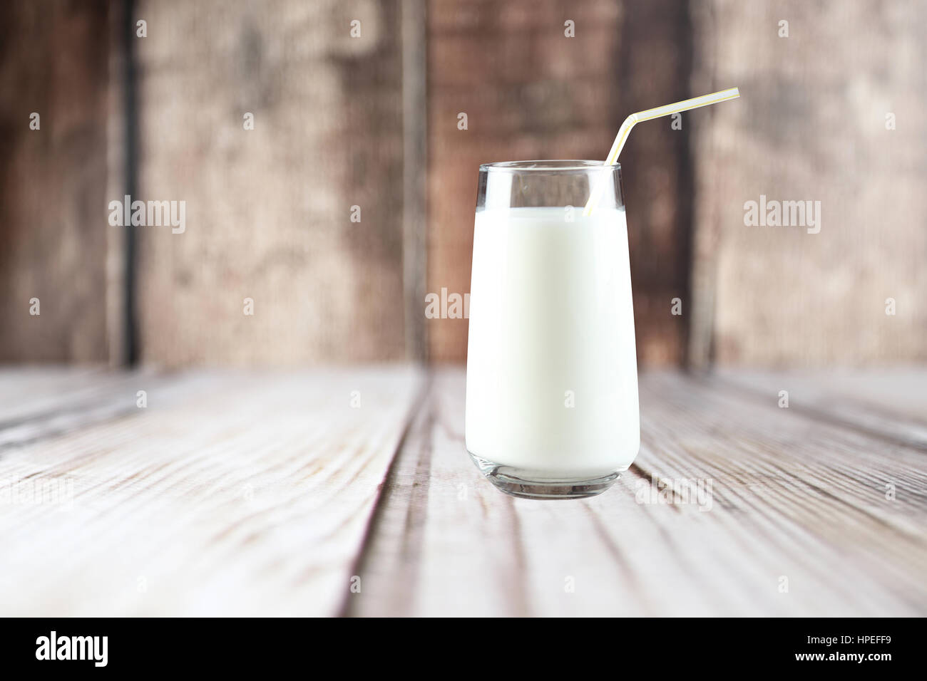 Glas Milch auf dem Tisch auf hölzernen Hintergrund mit selektiven Fokus Stockfoto